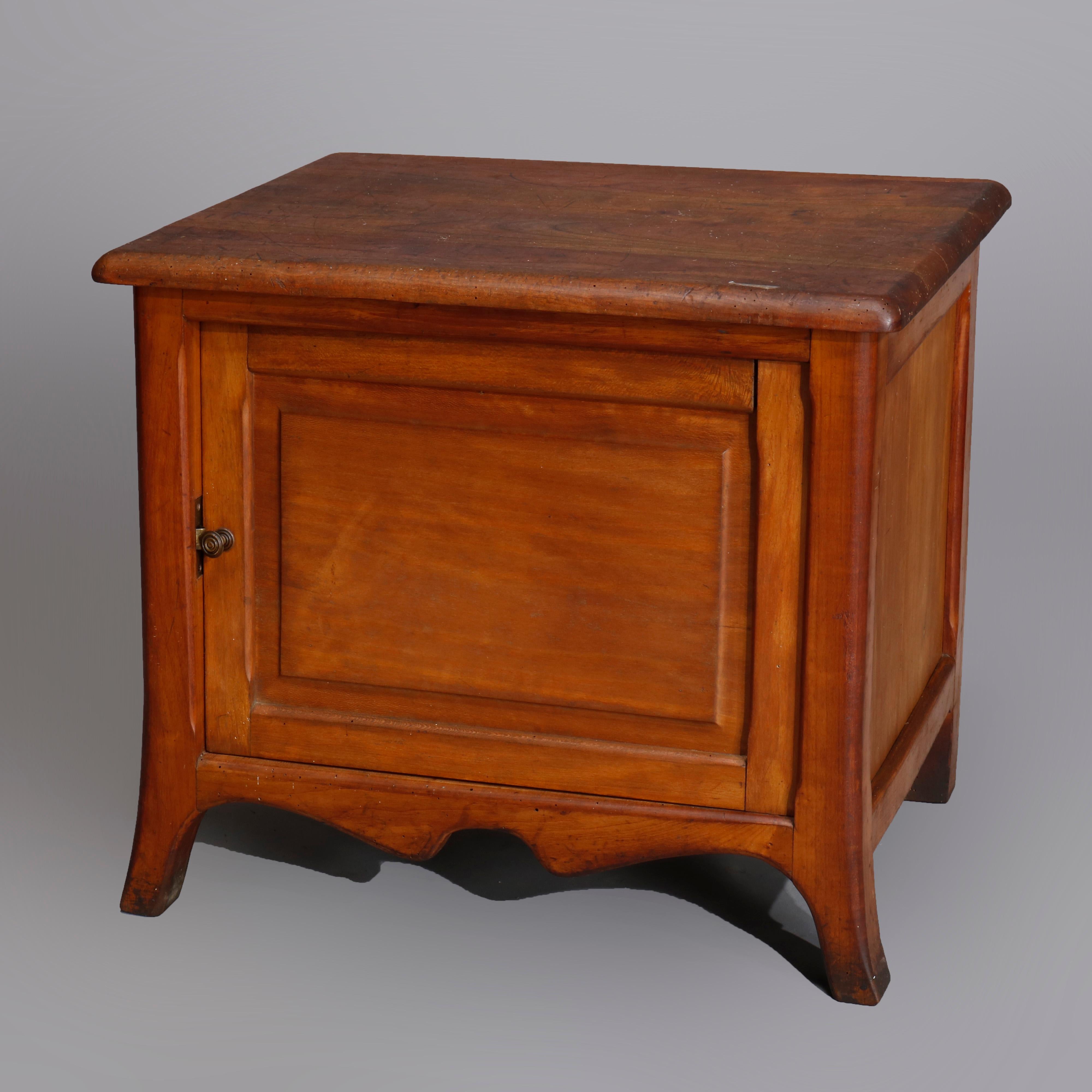 Vintage pair of maple box form single door side stands with raised panels, shaped skirt and raised on tapered and flared feet, interior storage cabinets, 20th century

Measures: 20.5