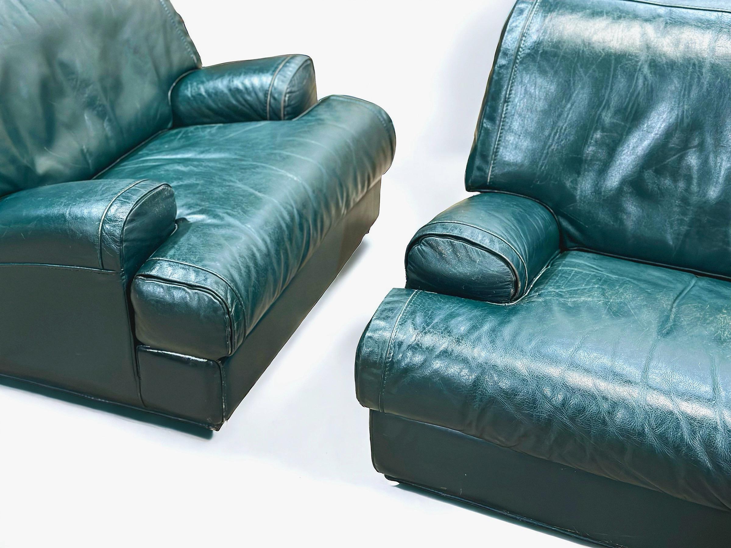 Exquisite pair of streamlined moderne or art deco style leather lounge chairs by Roche Bobois, France circa late 1970s. Striking silhouette and opulent comfort. The full grain teal leather has aged to perfection. These chairs are unique on the world