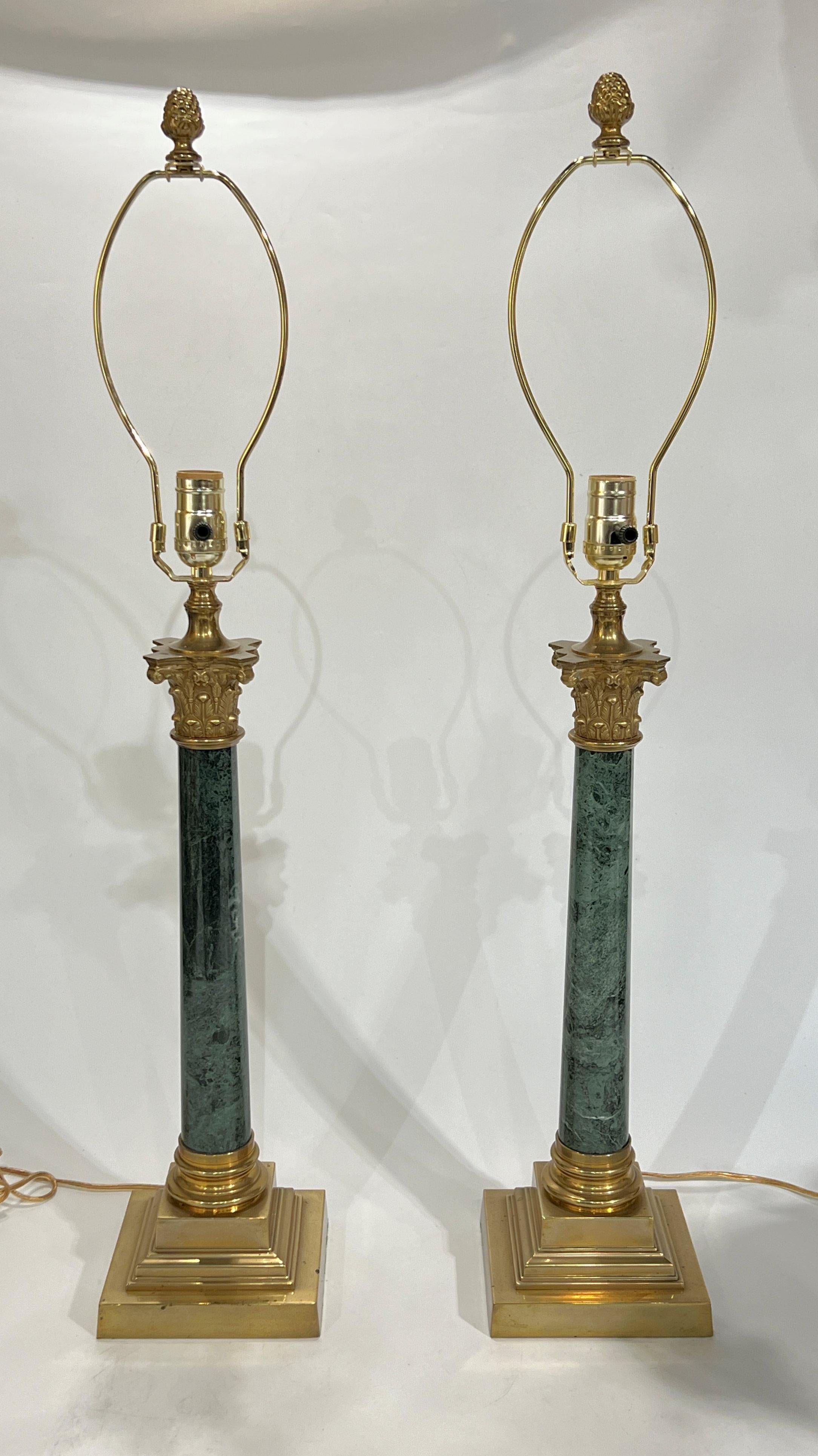 Pair of vintage Empire style table lamps of Roman column form, finely crafted from variegated green marble with brass mounts including Corinthian style capitals and square stepped bases.  With cord and plug, ready for use.