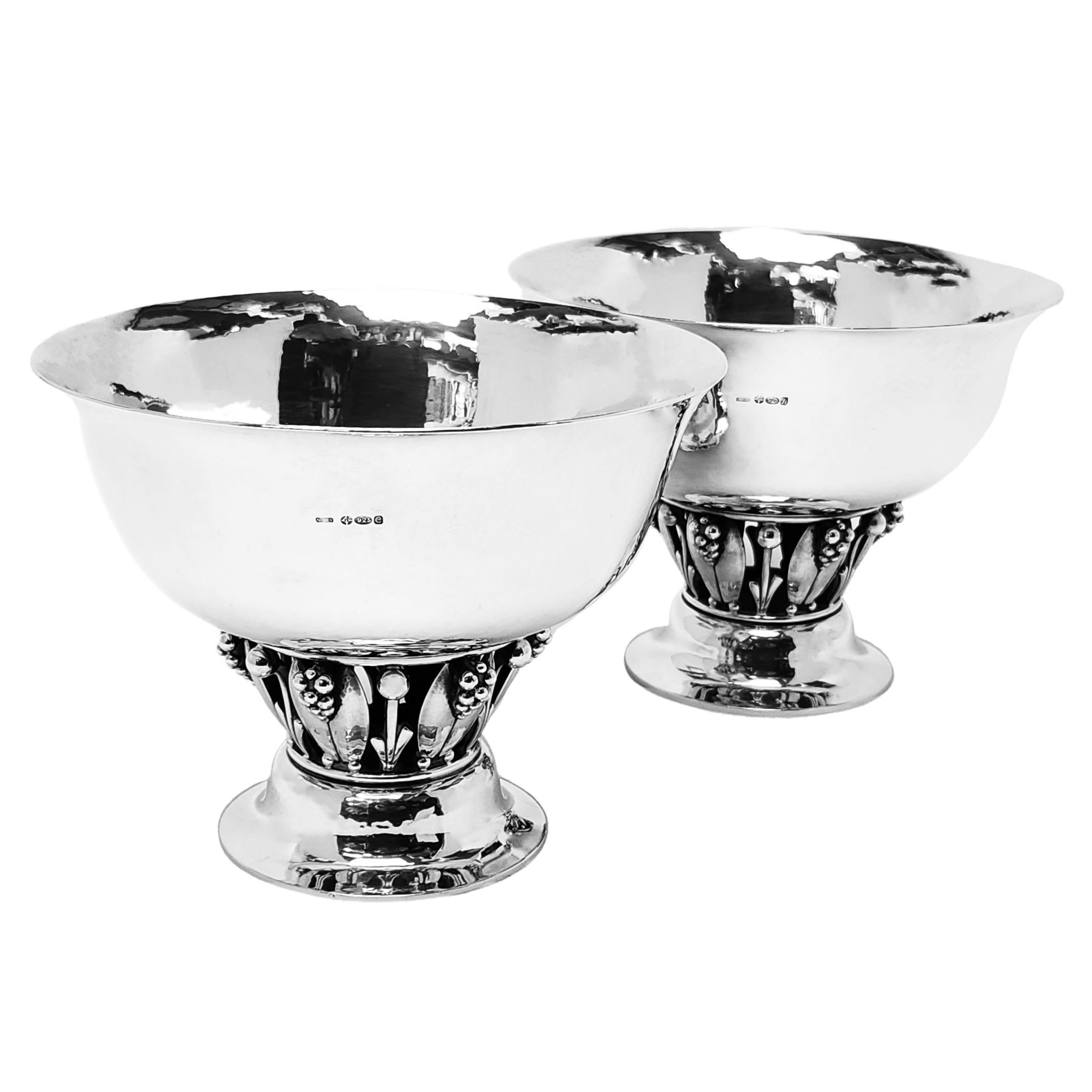 A pair of elegant Sterling Silver Bowls in classic Jensen design pattern 197B. The pair of Bowls are supported on berry and leaf design colons and the bodies of each bowl features a subtle lightly hammered finish.

Made in Copenhagen, Denmark by