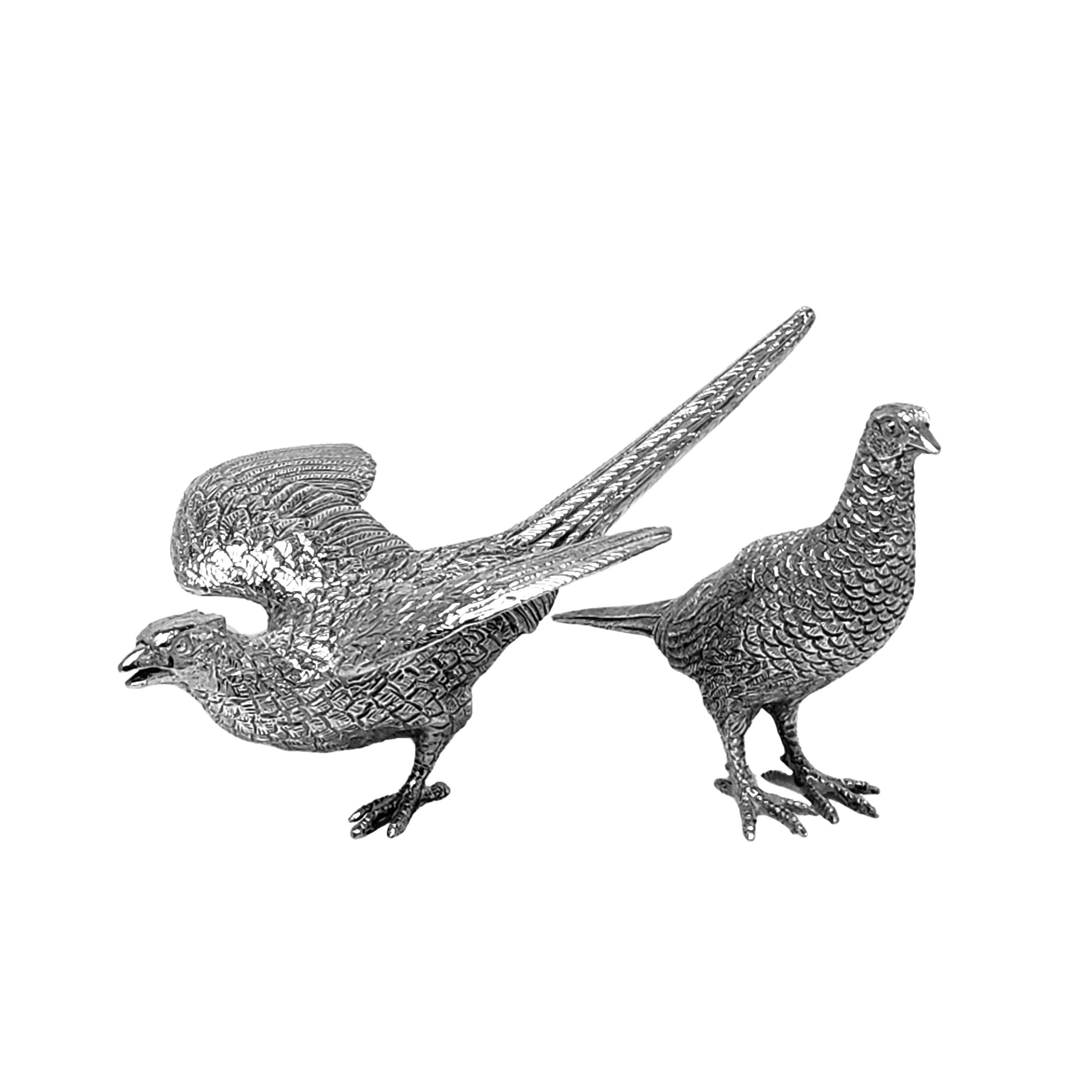 A pair of charming Vintage Sterling Silver Model Pheasants of excellent quality and notably heavy weight. The pair are modelled as a cock pheasant and a hen pheasant.

Made in Birmingham, England in 1971 and 1988 by Albert Edward Jones.

Approx.