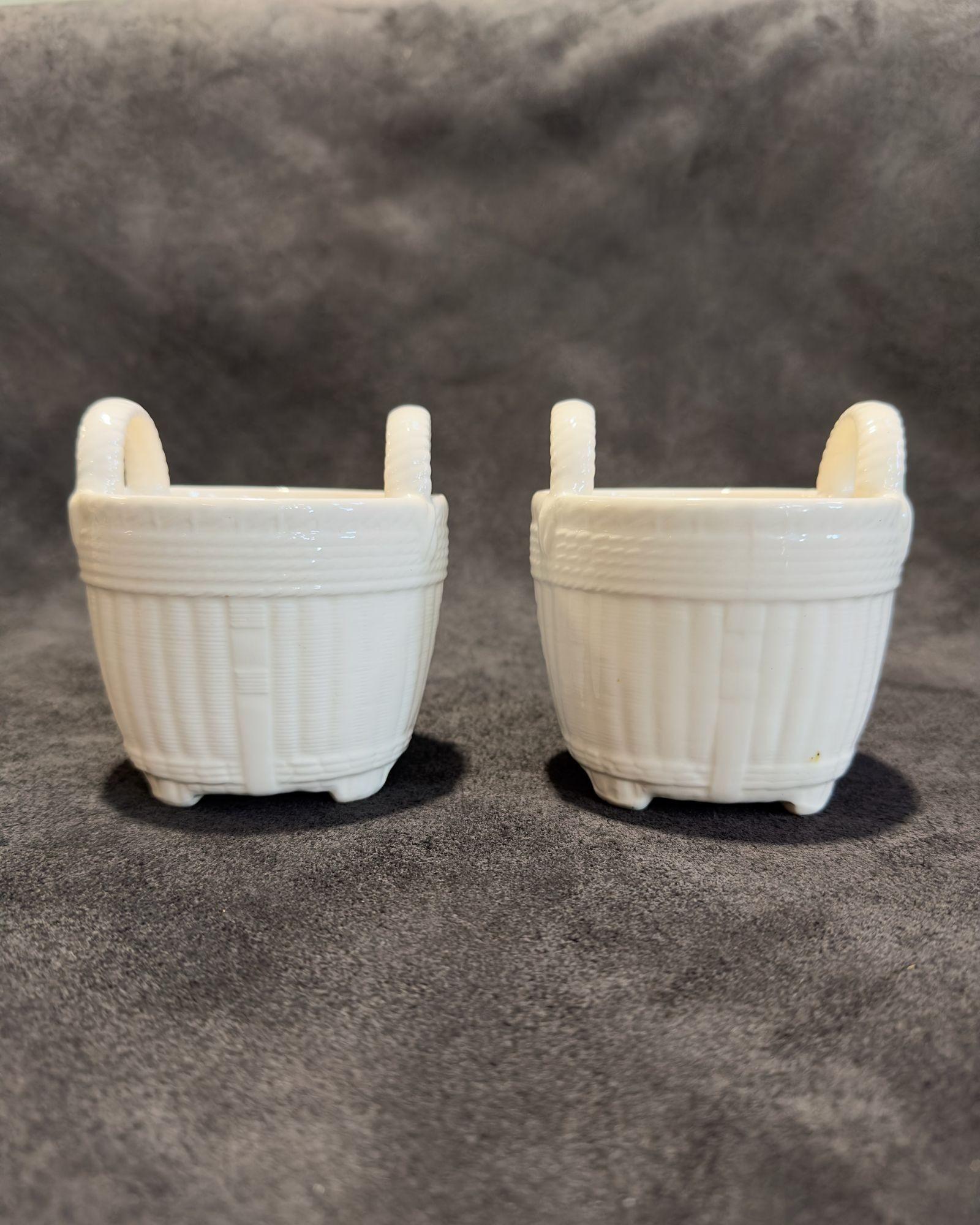 Pair Vintage Tiffany & Co. Ceramic Weaved Baskets, 1960.
Creamy white ceramic footed baskets made by Tiffany & Co. stamped on bottom in blue.
Measure 4.5