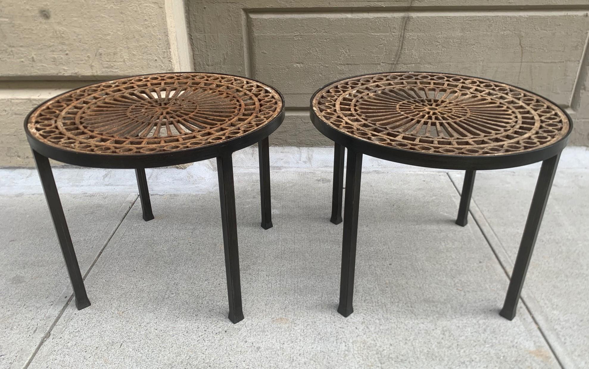 Pair of vintage Victorian tables with cast iron tops. The tables have an antique grill insert set on newer iron bases.