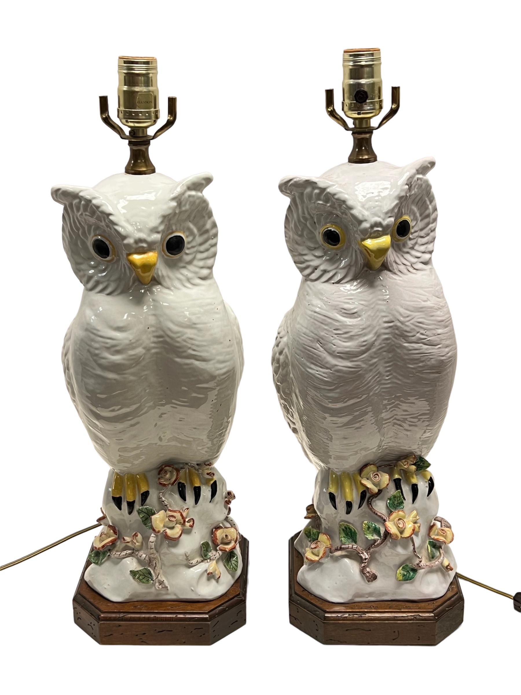 Pair of mid-century modern glazed ceramic owls mounted as table lamps with carved wooden pedestals, believed to be of Italian origin.  Ready for use.