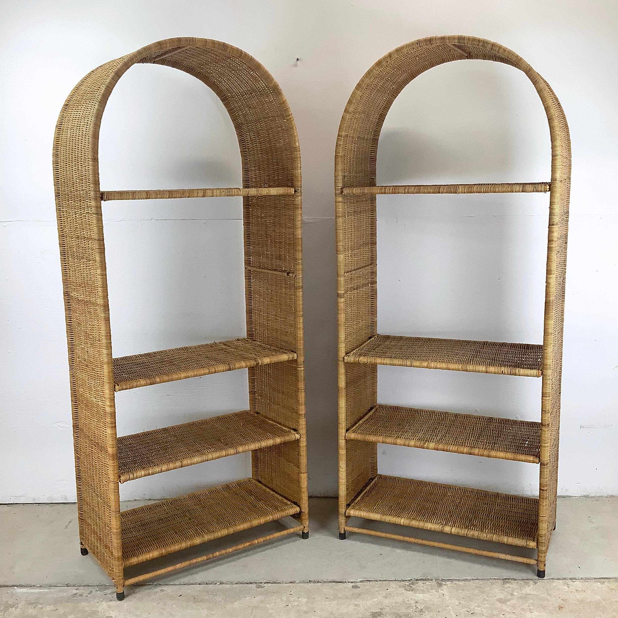 Transform your living space with this exquisite pair of Vintage Woven Rattan Arched Etageres. With their unique tops and vintage wicker frames, these etageres offer a perfect blend of boho charm and practicality. The natural rattan shelves provide a