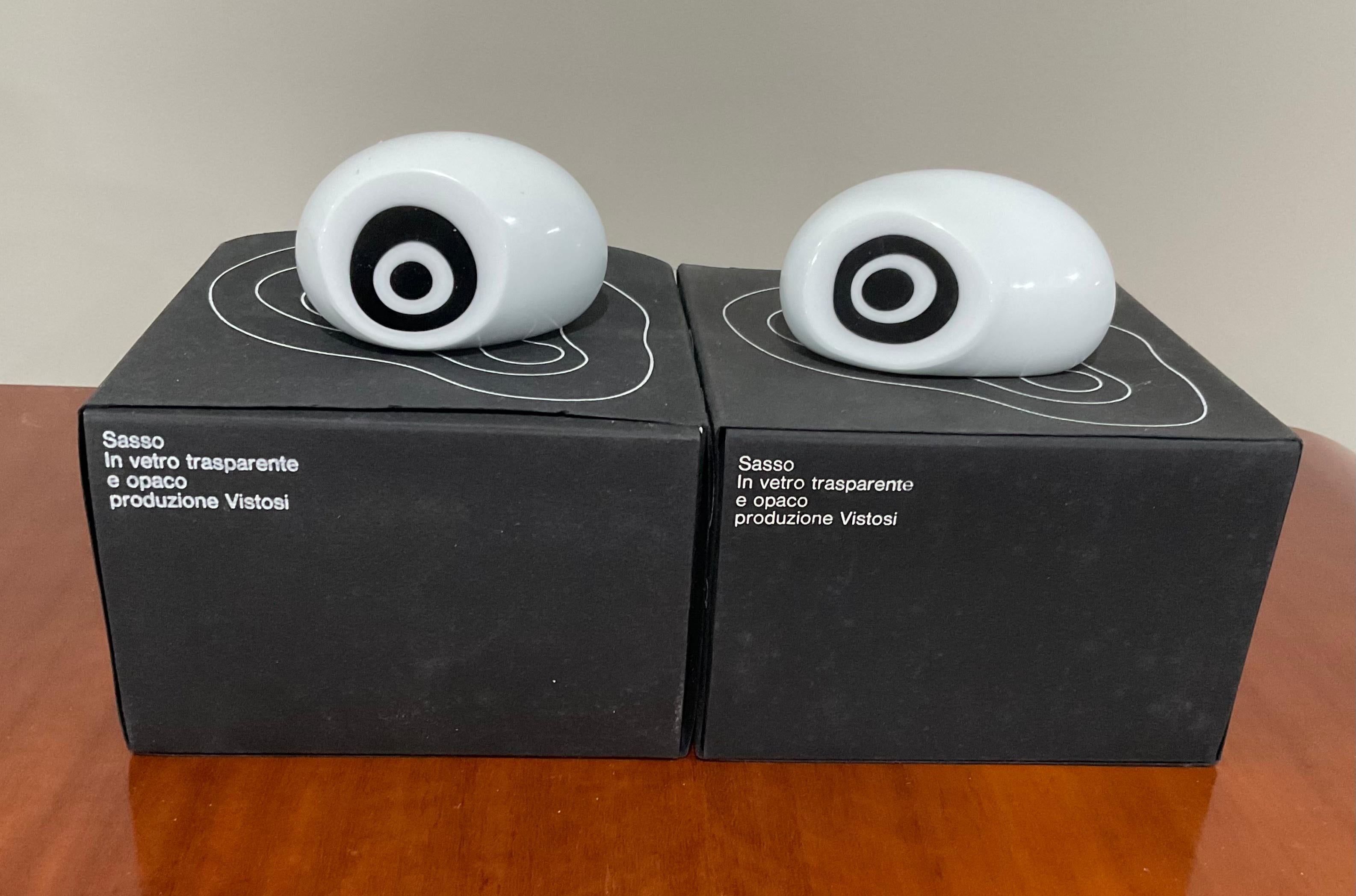 New Old stock pair of Vistosi Murano S562 Sasso Stone hand blown glass objects to resemble eyes. Both in the pair retain the original box and packaging. Brilliant white color is the primary, with layered black. See the mirror image sculptures in