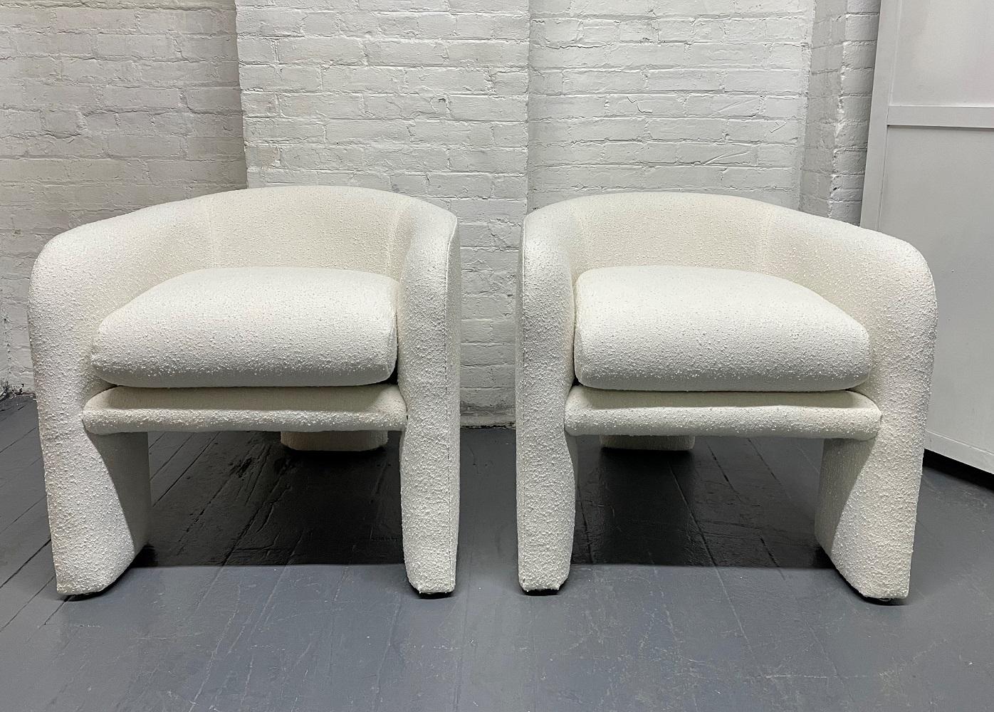 Pair of upholstered three-legged sculptural lounge chairs in Bouclé by Weiman / Preview.