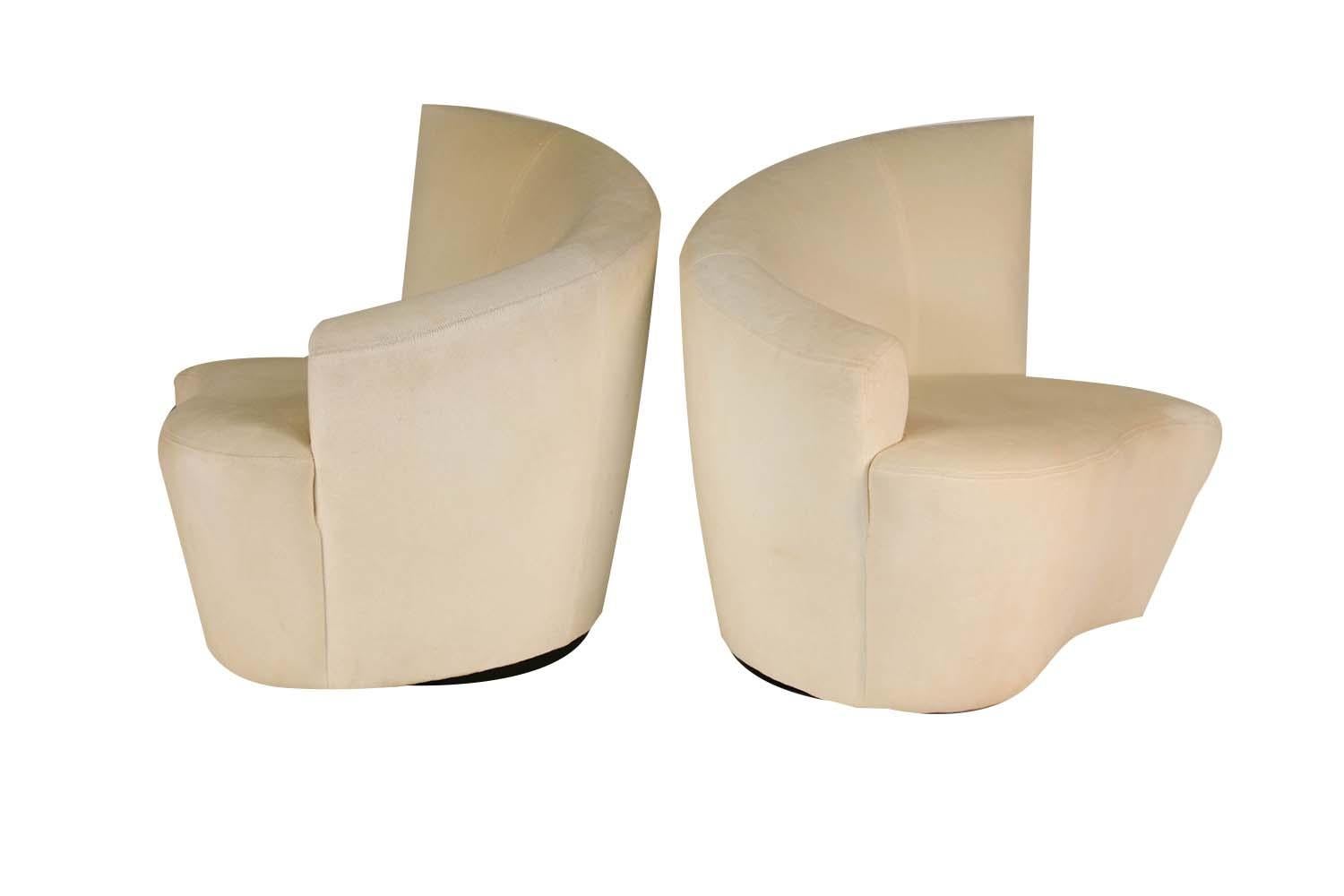 Superb pair of sculptural Bilbao swivel lounge chairs designed by Vladimir Kagan for Weiman Preview. Features beautiful and uniquely stylish shaped, curved angular backrests/armrests, with comfortable plush seats. Chairs rest on circular swivel