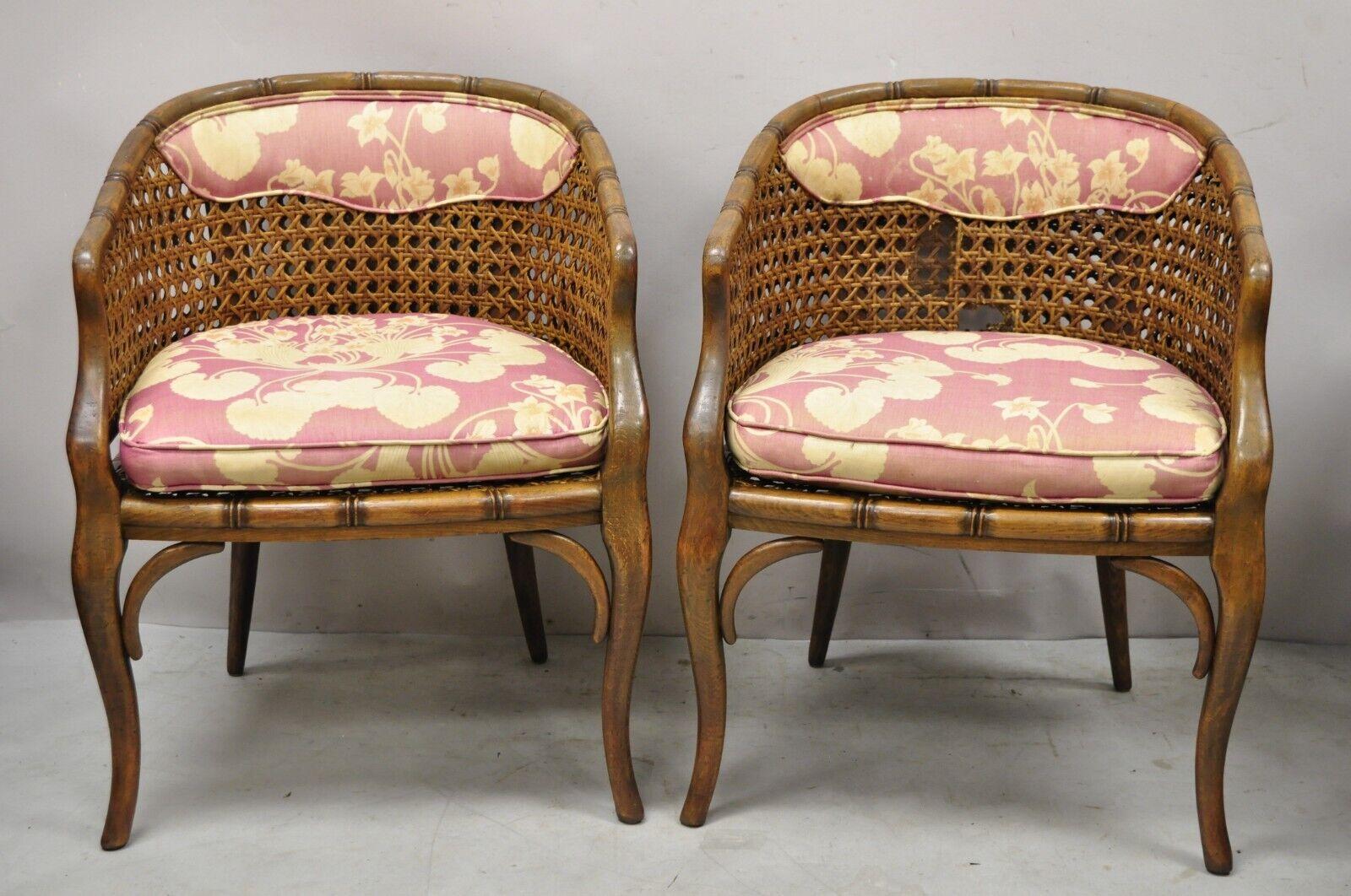 Pair of Vintage Hollywood Regency Faux bamboo cane barrel back club lounge chairs (A). Item features cane seat and back, faux bamboo carved wood frames, very nice vintage pair, great style and form. Circa Mid 20th Century. Measurement 31
