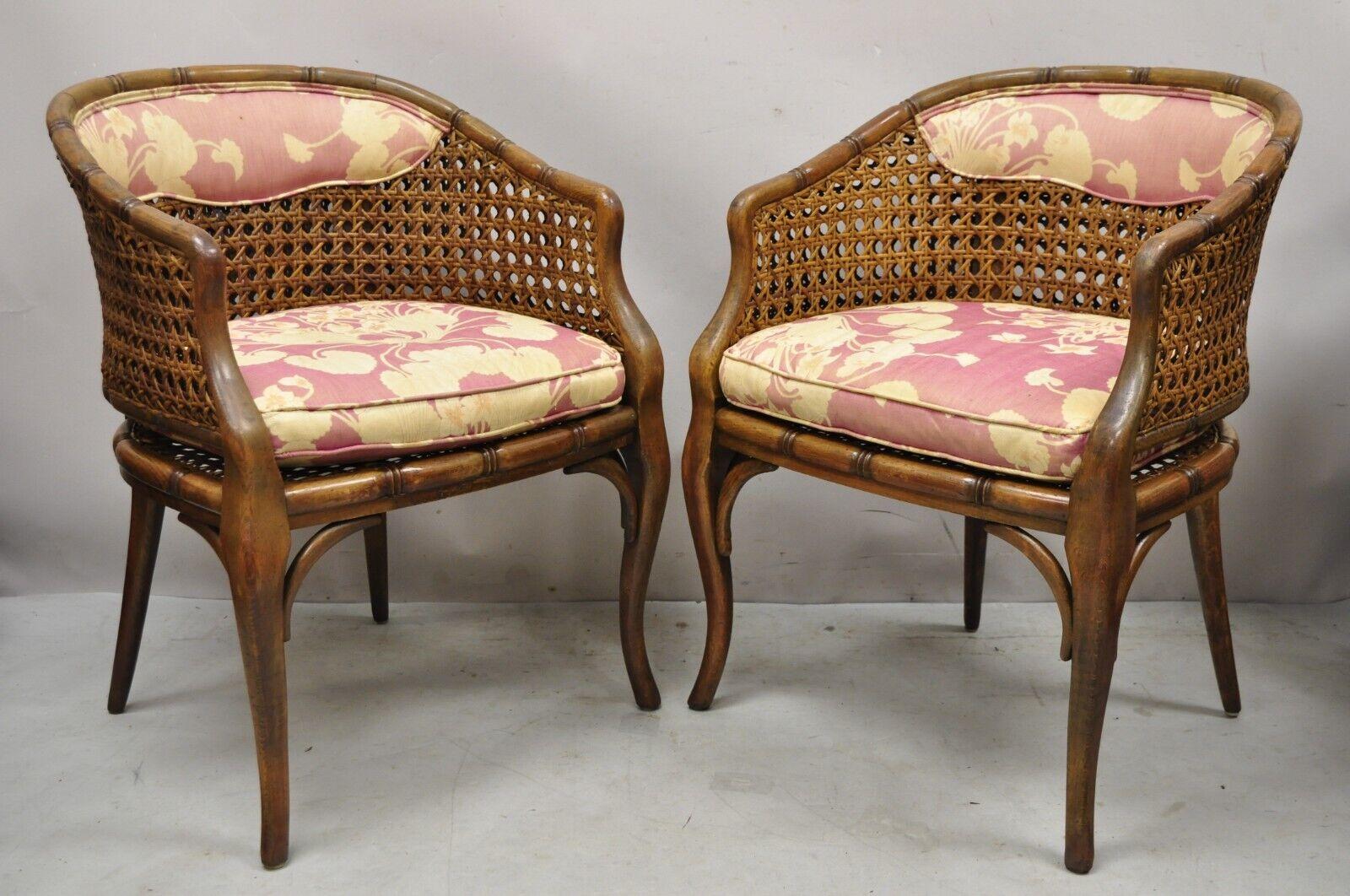 Pair of Vintage Hollywood Regency Faux bamboo cane barrel back club lounge chairs (B). Item features cane seat and back, faux bamboo carved wood frames, very nice vintage pair, great style and form. Circa Mid 20th Century. Measurements: 31