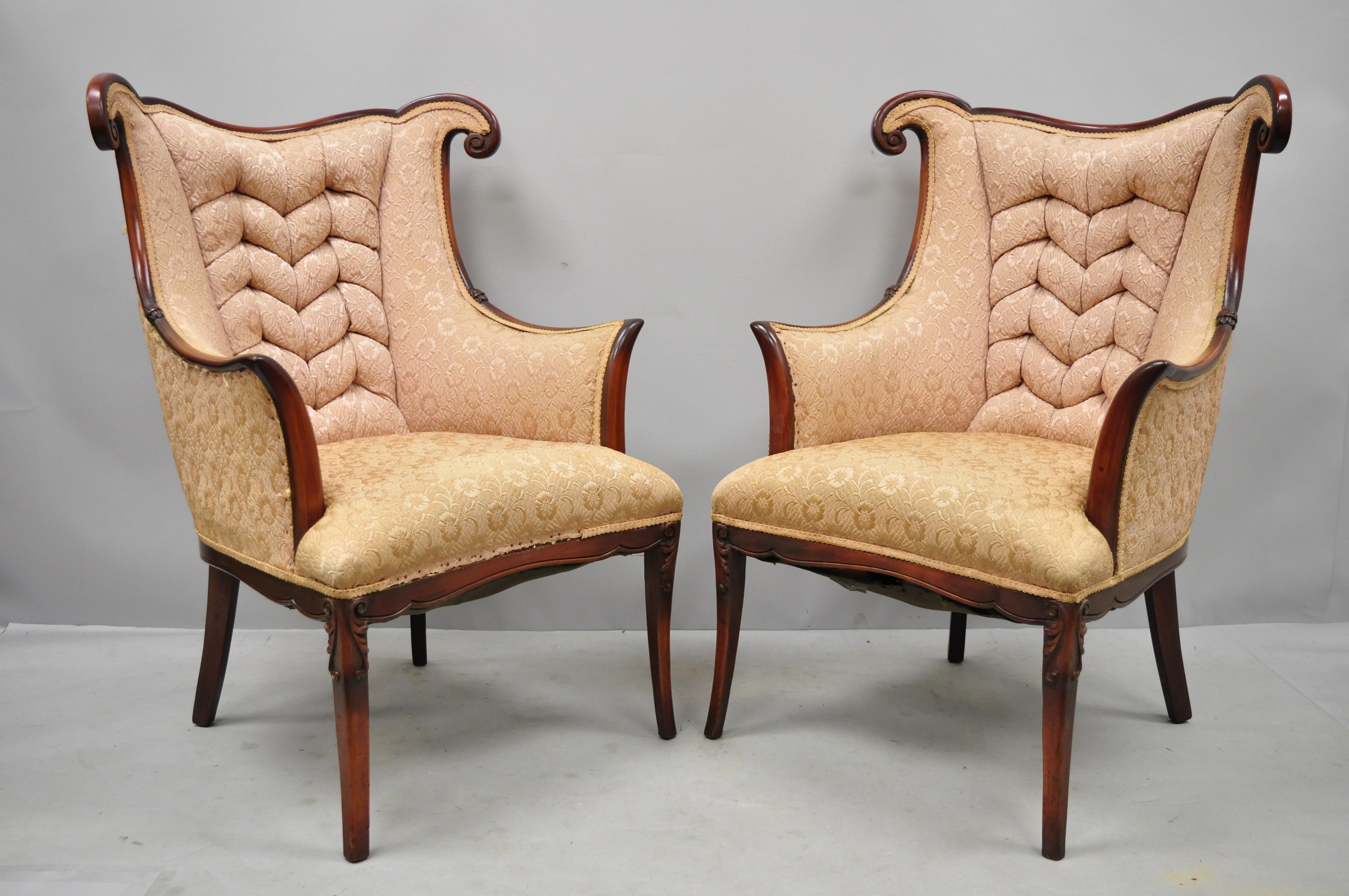 Pair of vintage Hollywood Regency French style mahogany armchairs after Dorothy Drapes. Item features solid wood construction, nicely carved details, tapered legs, sleek sculptural form, circa early to mid-20th century. Measurements: 41