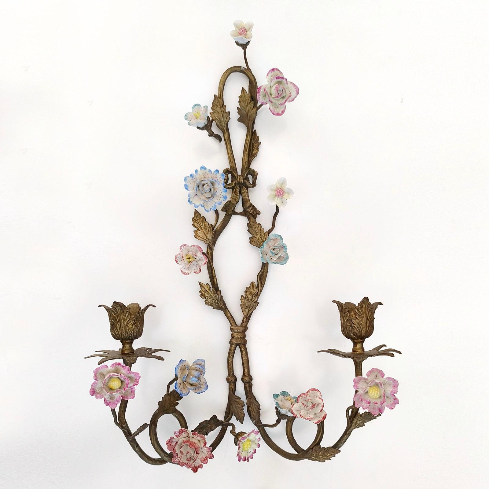 Pair Wall Appliques, Wall Sconces, Bronze and Porcelain Flowers, France 1900s

Bronze sconces for two candles, with the decoration of different-shaped flowers in porcelain. 
Height approx. 45 cm.
Good overall condition, bronze naturally aged, minor