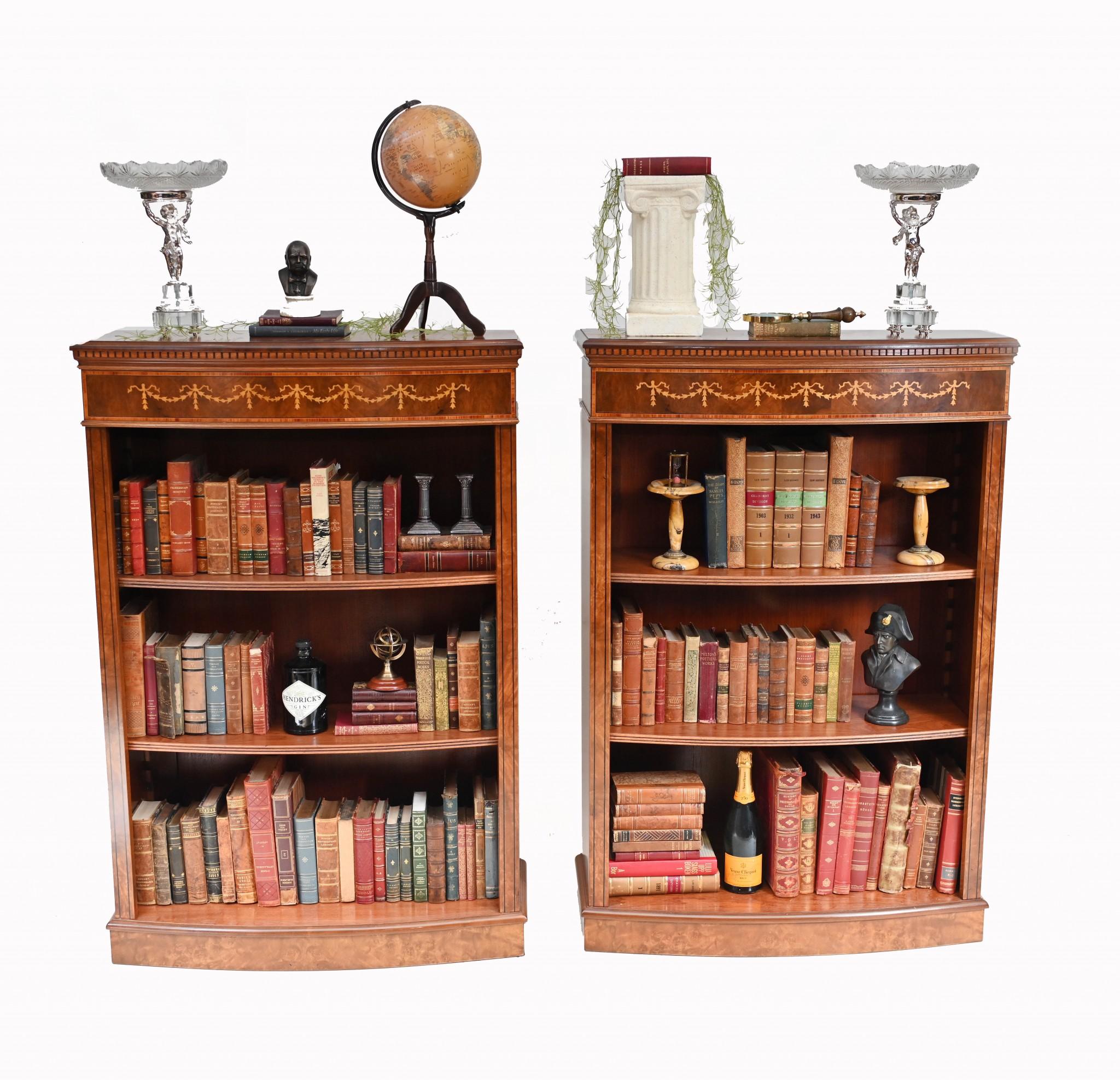Wonderful pair of walnut open front bookcases in the Sheraton manner
Hand crafted from walnut with satinwood inlay, these are the ultimate in classic English library furniture
The front sees the garlands and reefs inlaid into the walnut, another