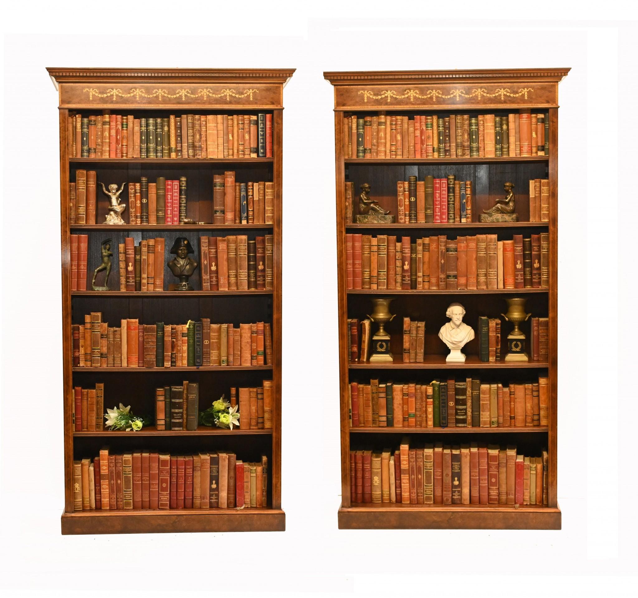 You are looking at a pair of English Sheraton style openfront bookcases hand crafted from the finest walnut. This lovely pair are the perfect mix of decorative beauty and practical functionality to make for a vintage design classic. They look great