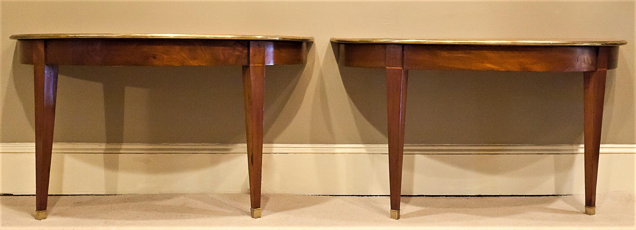 These neoclassical consoles are probably Northern Italian. They appear to have been originally banquet ends from a dining room table. The back skirt has been adapted to allow them to either be easily attached to a wall for use as consoles, or bolted