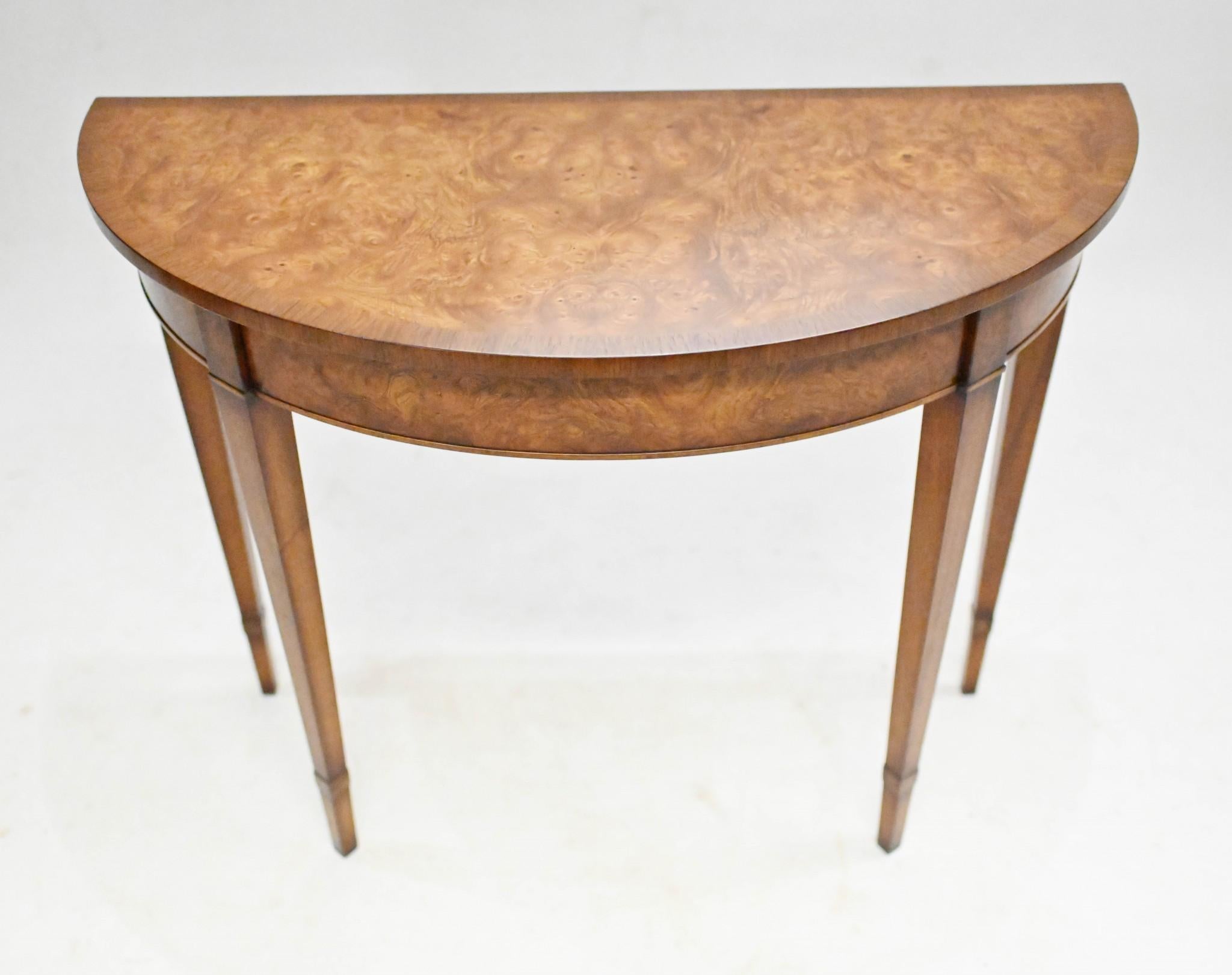 Pair opulent walnut console tables in the Adams manner
Demi lune - half moon - form 
Classically refined with clean design and tapered legs
Great finish to the walnut
Offered in great condition ready for home use right away
Will ship to anywhere in