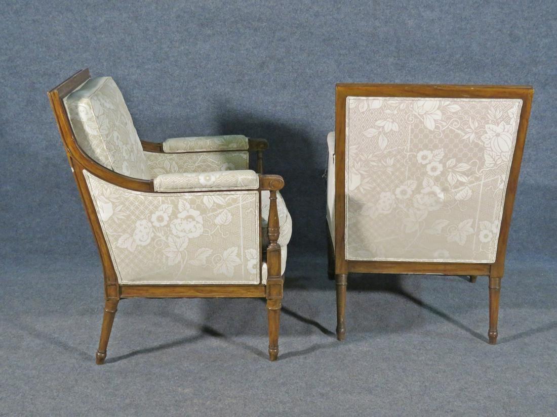 This is a nice pair of ready to re-imagine French Louis XVI style bergere chairs. With their Classic square backs these chairs can work in any environment and would be gorgeous with painted frames and some spectacular fabric on them. Carved walnut