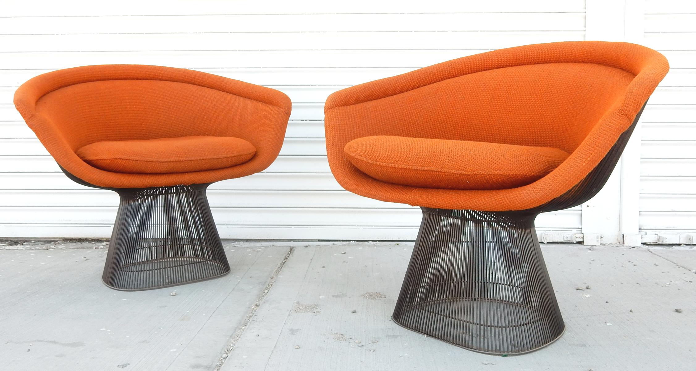 Extra extraordinary pair of the iconic wire lounge chair designed by Warren Platner for Knoll International., dated 1978.
Original Knoll orange upholstery on anodized black wire frames. Both labelled under seat cushion.
These chairs are clean and