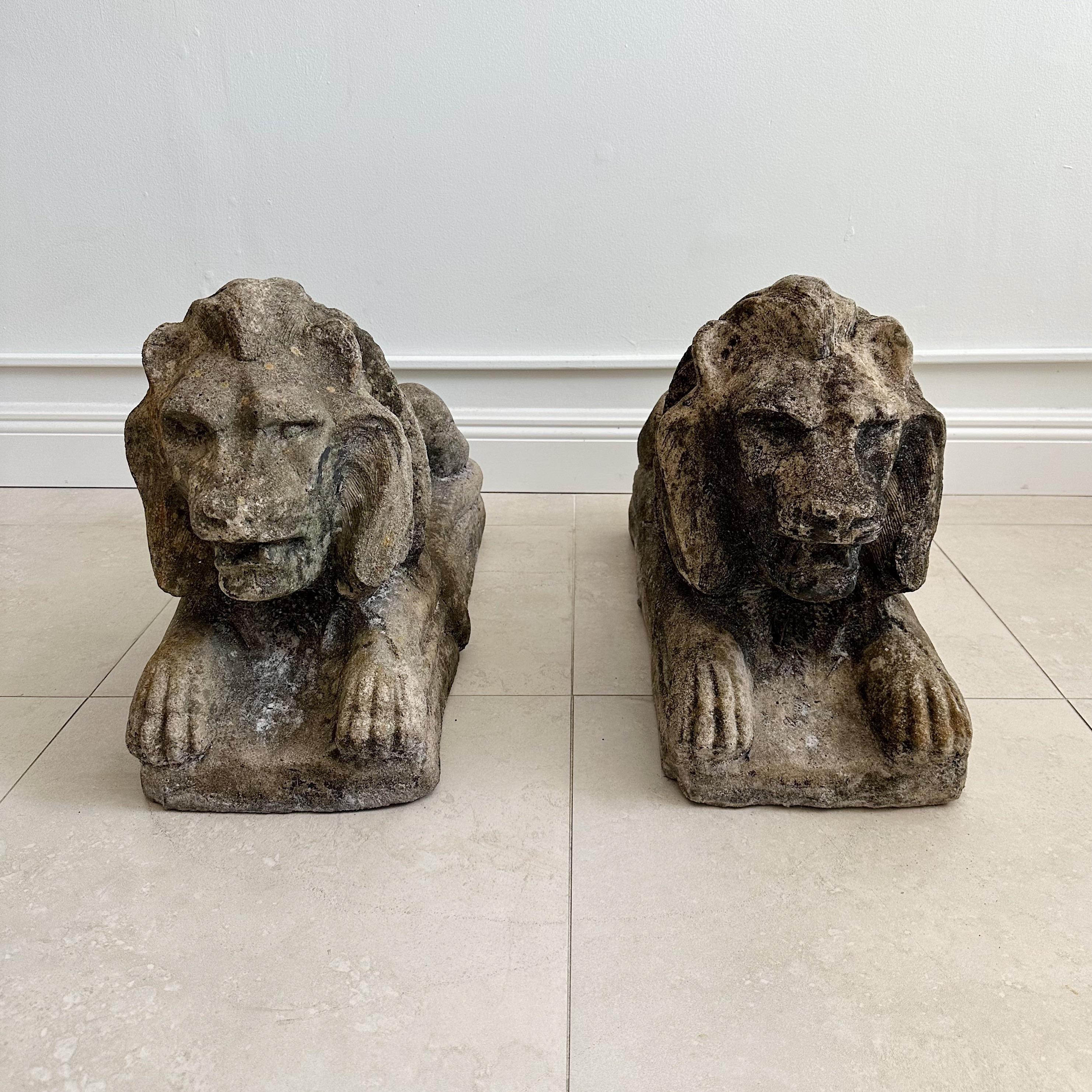 Pair of reclining cement Lions from the mid 20th century with a lovely weathered patina, in excellent vintage condition.