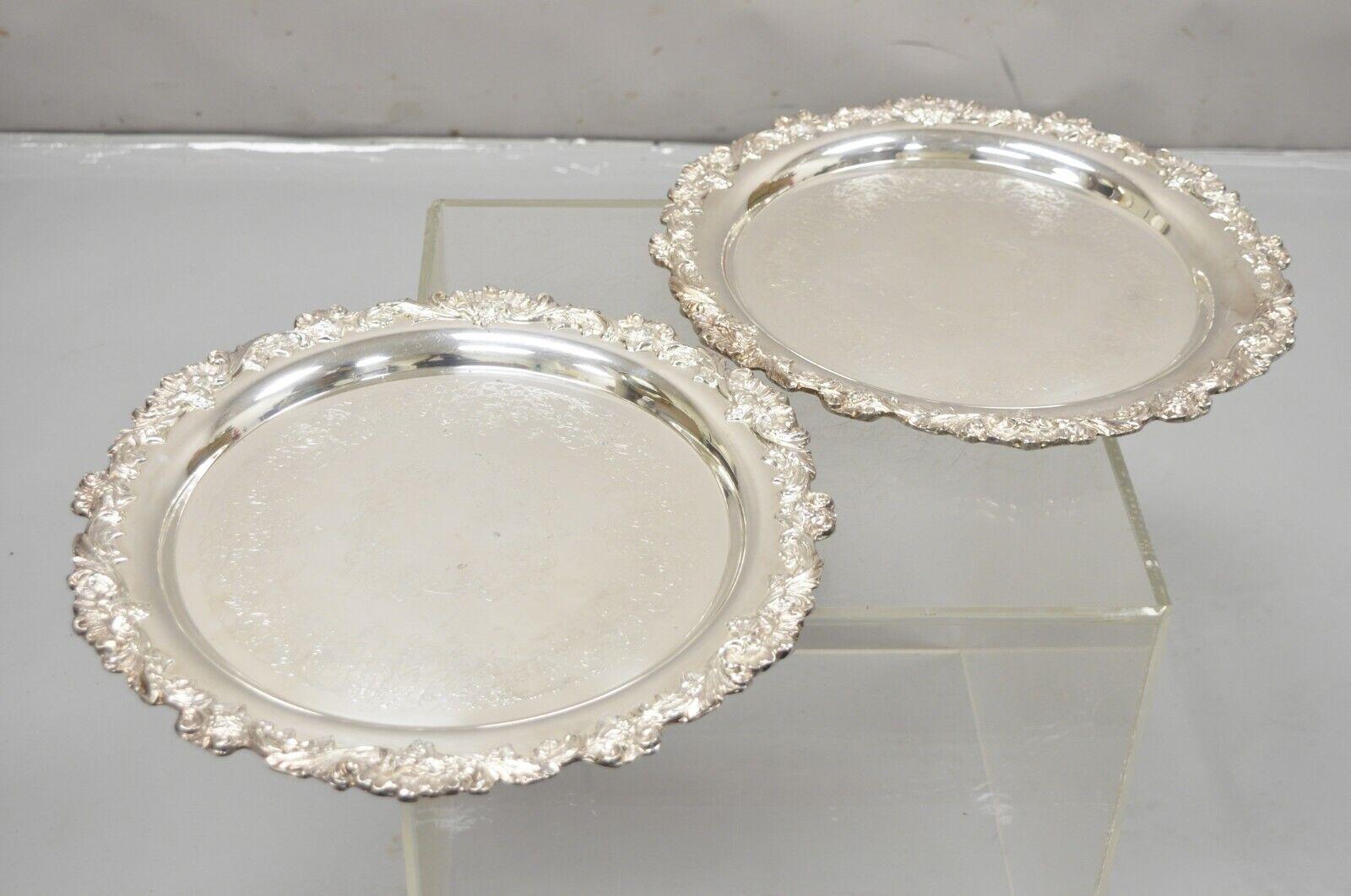 Vintage Pair Webster Wilcox International Silver Plated 16” Round Serving Platter Tray. Item features etched centers, ornate rim, original hallmark. Circa Mid 20th century. Measurements:  1