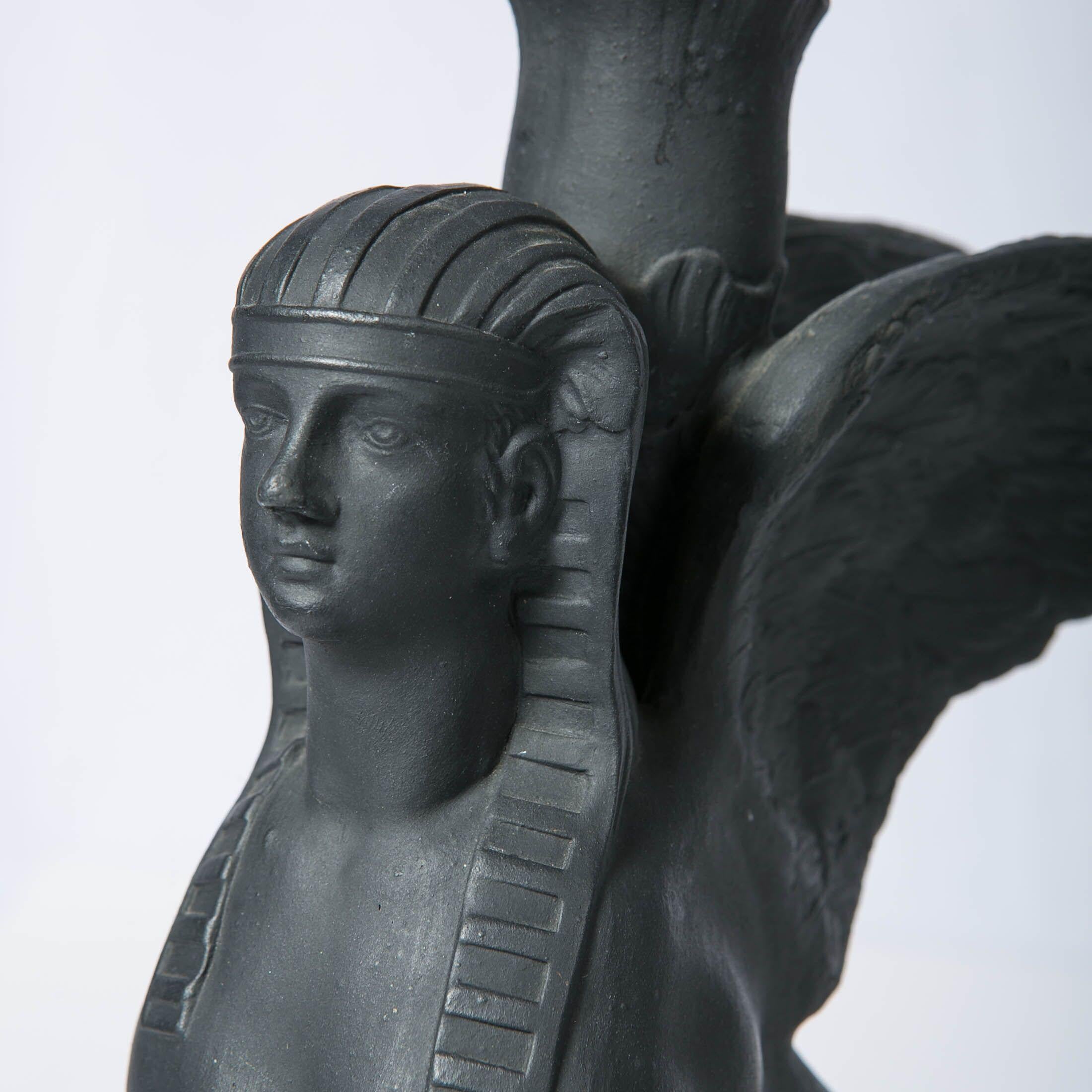 These stunning Wedgwood black basalt sphinxes are a true masterpiece of Wedgwood craftsmanship and artistry. These mythical creatures are a sight to behold with their majestic woman's head, mighty lion's body, and elegant wings. 
 Each sphinx sits