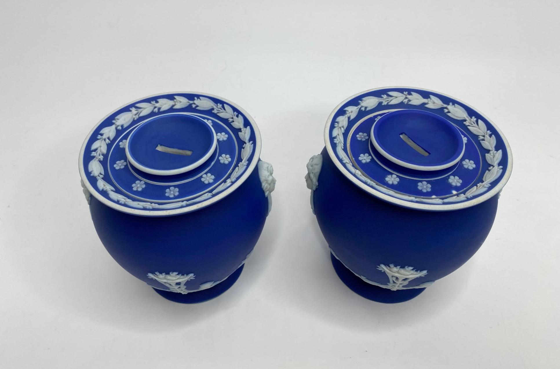 Rare pair of Wedgwood fumigators, c. 1850. Made for ‘Piesse and Lubins, Fumigating Ribbon’. The globular blue jasper jars, sprigged with Classical scenes of a child, playing a pipe, with a dog, before a snake entwined, tripod burner, vases of