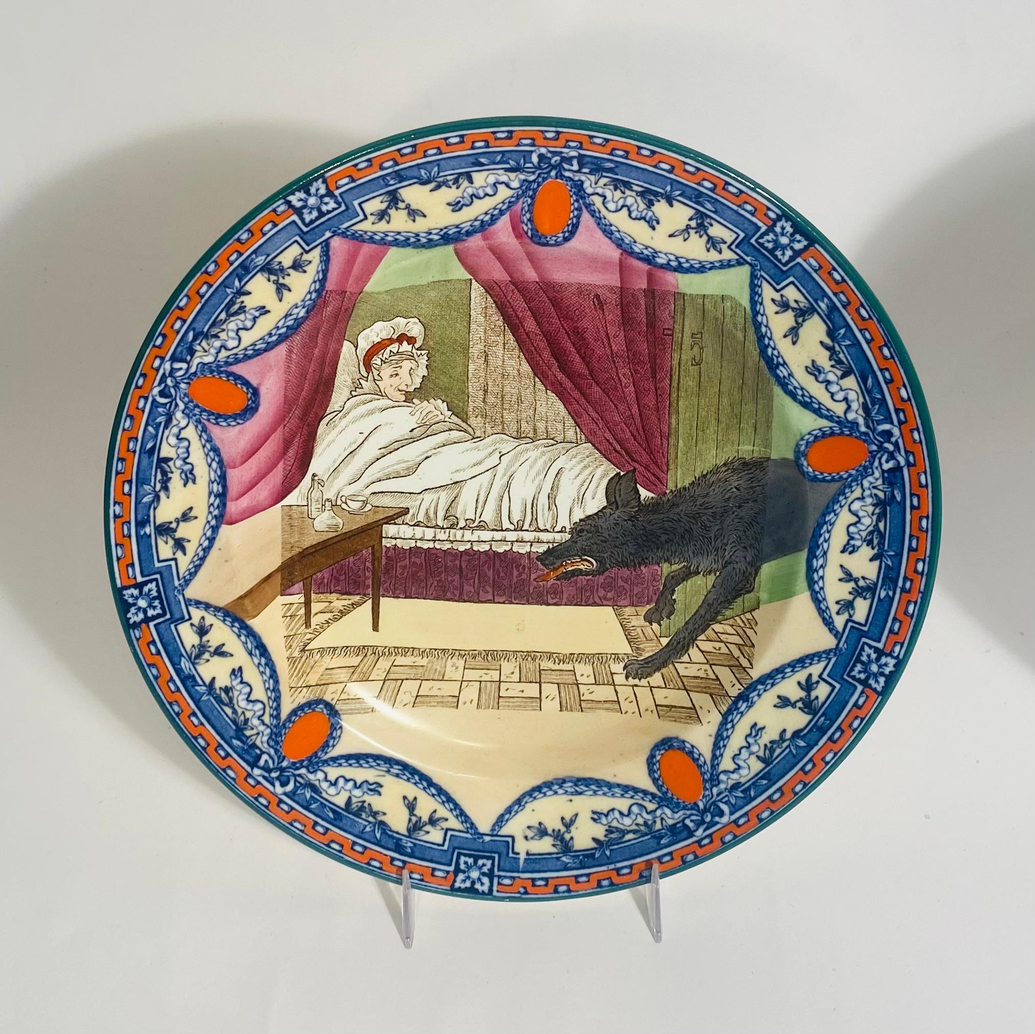 Collector Quality set of 2 plates from Wedgwood's iconic Little Red Riding Hood Series. A combination of detailed transferware and hand coloring brings these plates to life. We have the wolf entering into Grandma's bedroom on the one plate and then
