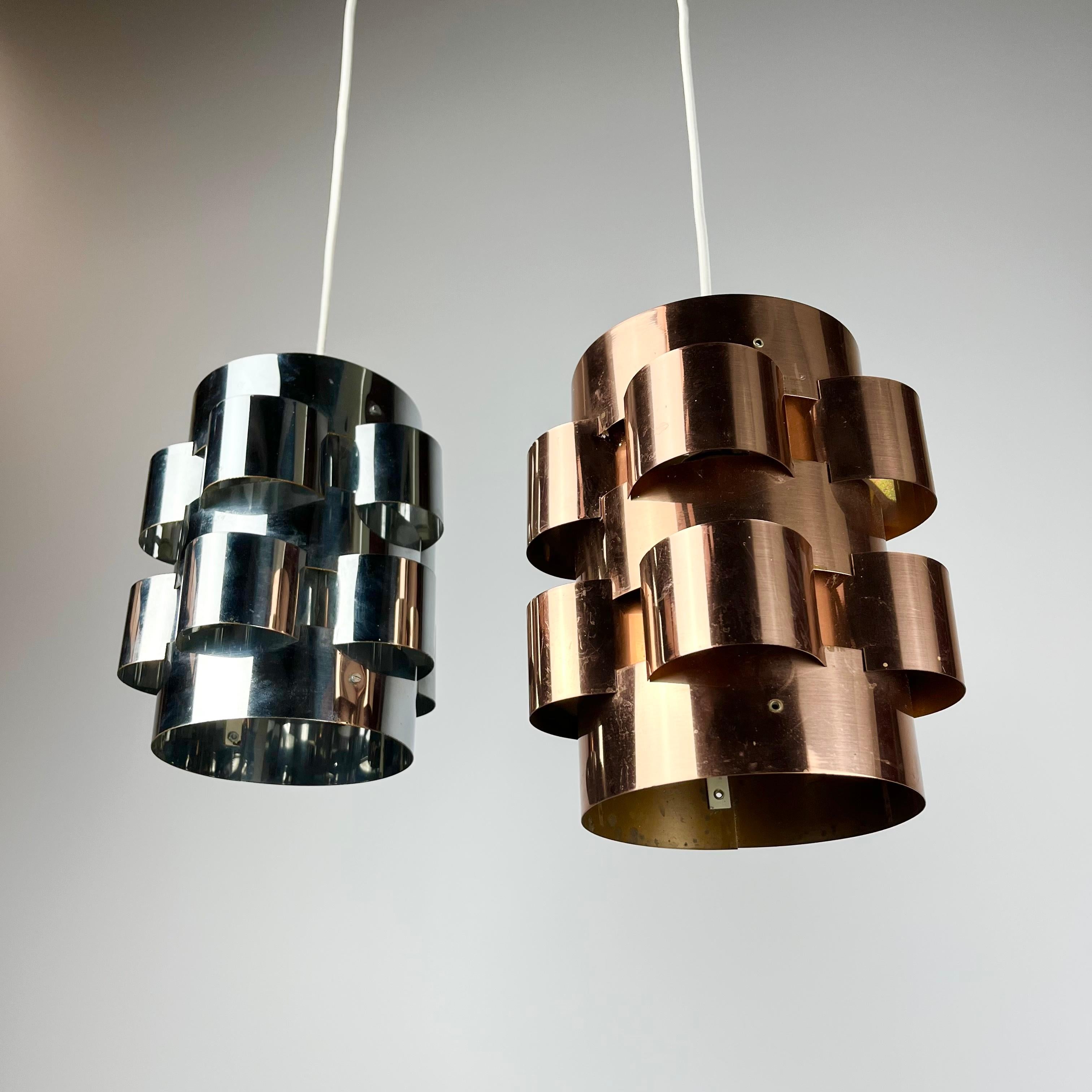 An ultra stylish pair of shiny metal light shades!
I believe these stunners were designed by Werner Schou and produced in Denmark by Coronell Elektro during the late 1960s to early 1970s, and are solidly constructed from heavy gauge chrome steel and