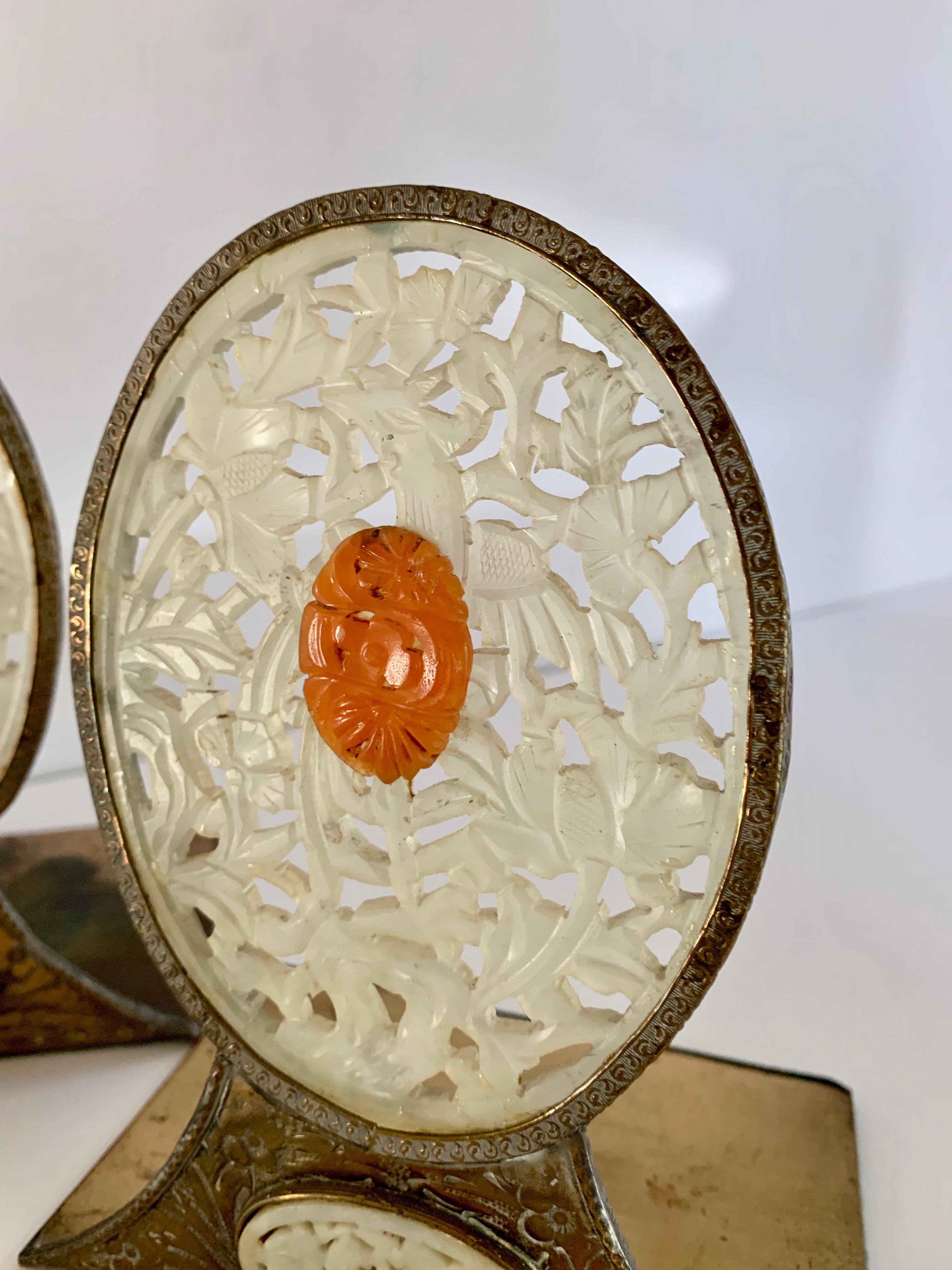 A wonderful pair of carved white jade and brass bookends, the pair have accents in Orange Jade and carved bone, with frame and stand in perfectly patinated brass - a stunning pair for the finest books in your collection. Perfectly suited for any