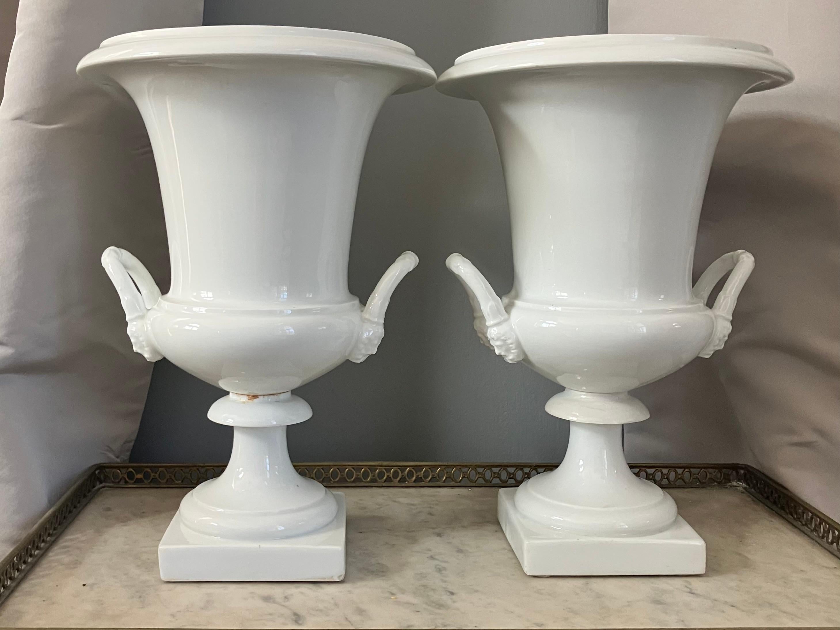 Pair White Neoclassical Campagna Vases. Pair of Paris Porcelain all white glazed porcelain two part vases with  double mask handles. France 1810. 

Dimensions: 9.5