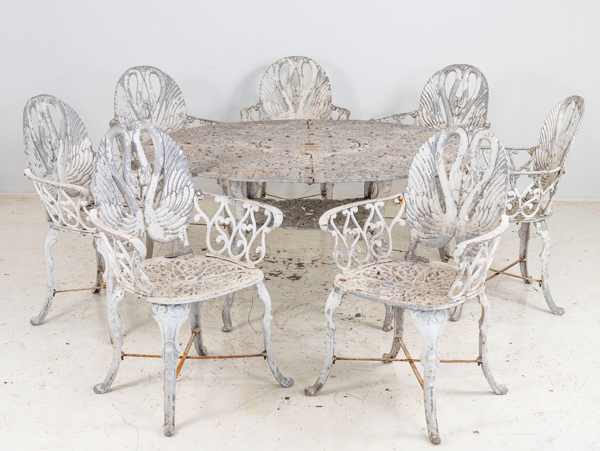 This charming pair of white-painted aluminum garden armchairs, crafted in Sweden during the 1960s, features an elegant design inspired by nature. The backs showcase graceful swans with elongated necks facing downward, creating a harmonious, mirrored