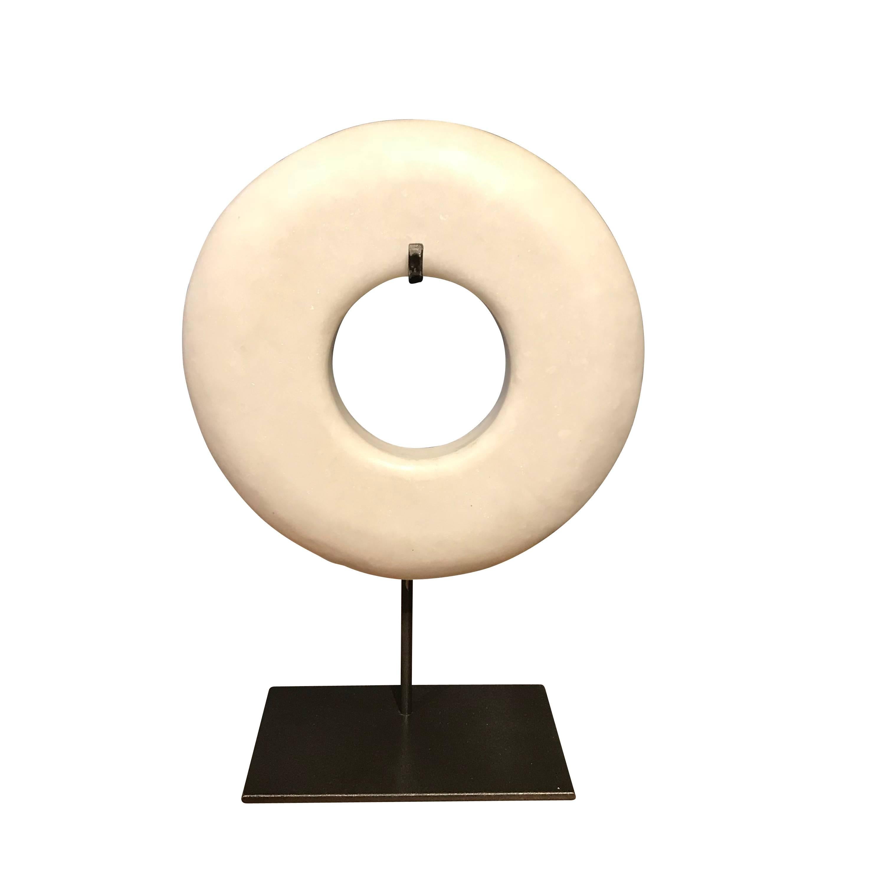 Contemporary pair of thick white stone ring sculptures on metal stands.
Stand measures 6