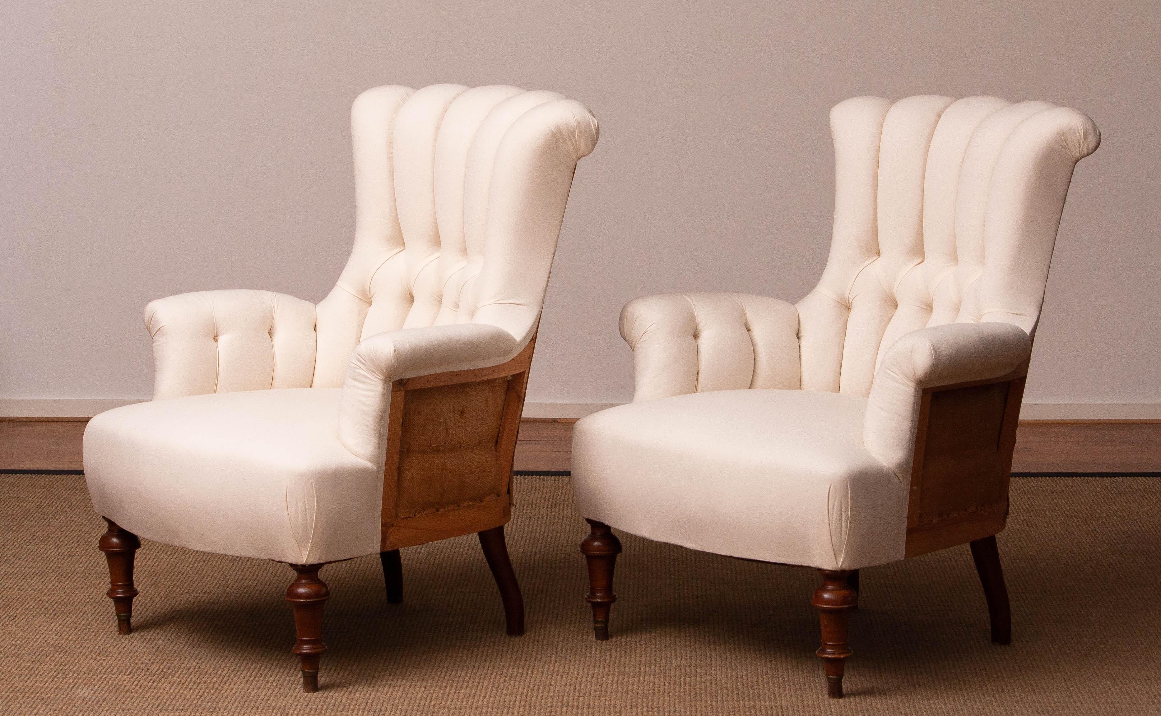 A stunning pair of original Victorian lounge chairs, professionally restored in a deconstructed style. Newly upholstered in domestic cotton, with replaced linen back, fillings, springs, bindings, and cords. These chairs provide excellent support