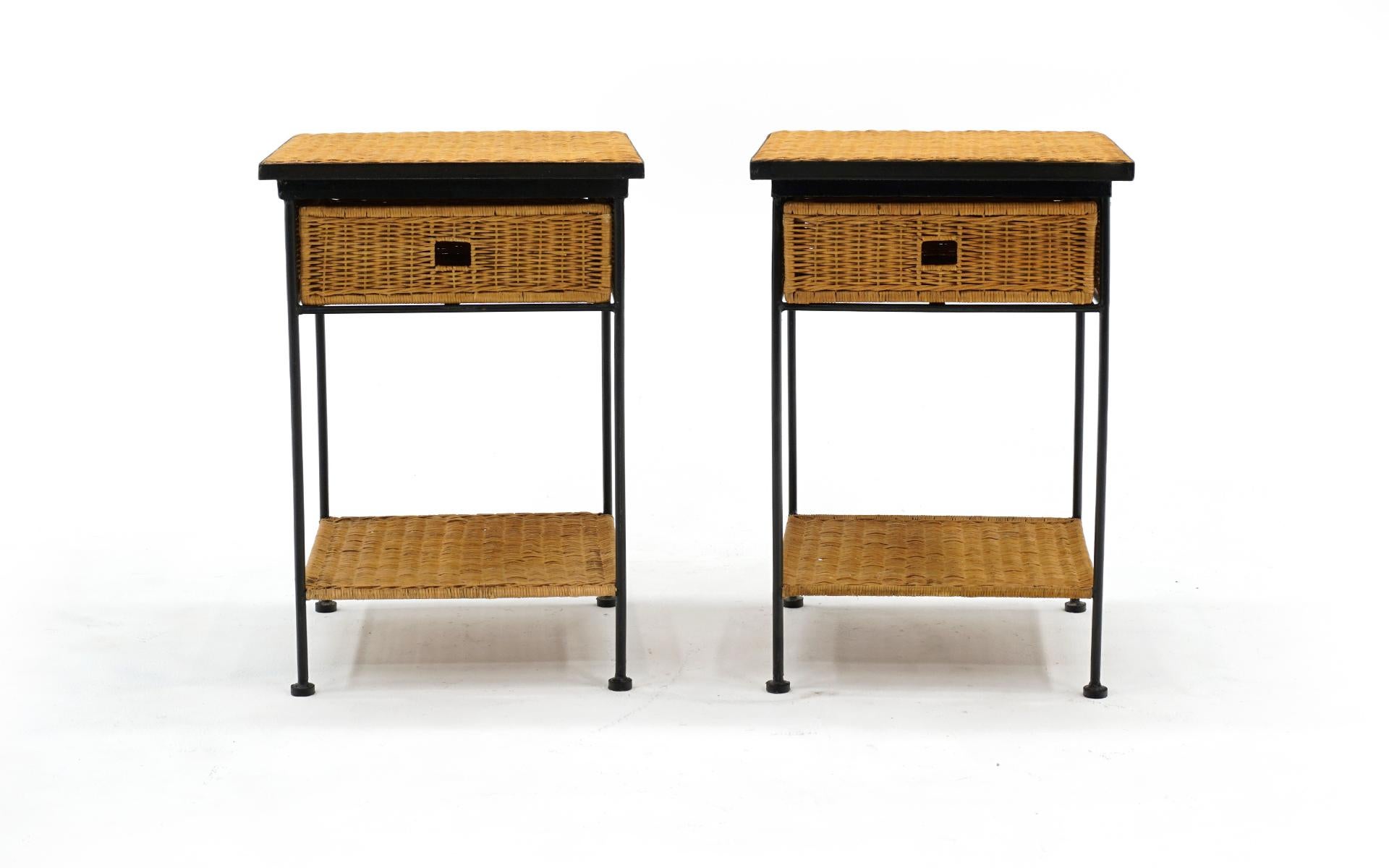 Pair of wicker and iron night stands / end tables with lower shelf similar to designs by Paul McCobb and Arthur Umanoff, The drawer in each functions smoothly. The wicker shows very few if any signs of use with no breaks, stains, or repairs. The