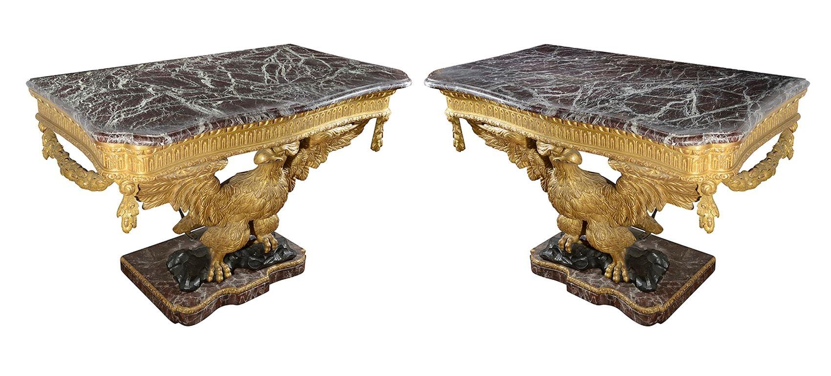 An imposing pair of 18th Century style William Kent Eagle console table, each with wonderful figures marble tops with carved moulded edges. Giltwood frieze with carved fluted decoration, garlands of Oak leaves and acorns, Eagles with outstretched