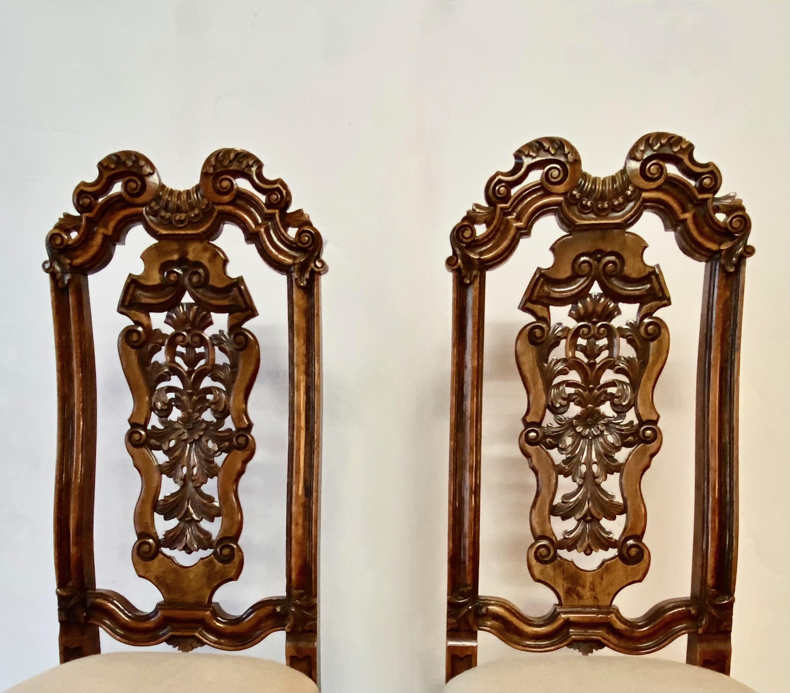 These beautifully carved high back William & Mary side chairs were created at the end of the sixteenth century c. 1690. The intricate carving of the legs, stretchers snd backs are indications of high quality. The 18th century hand forged irons that