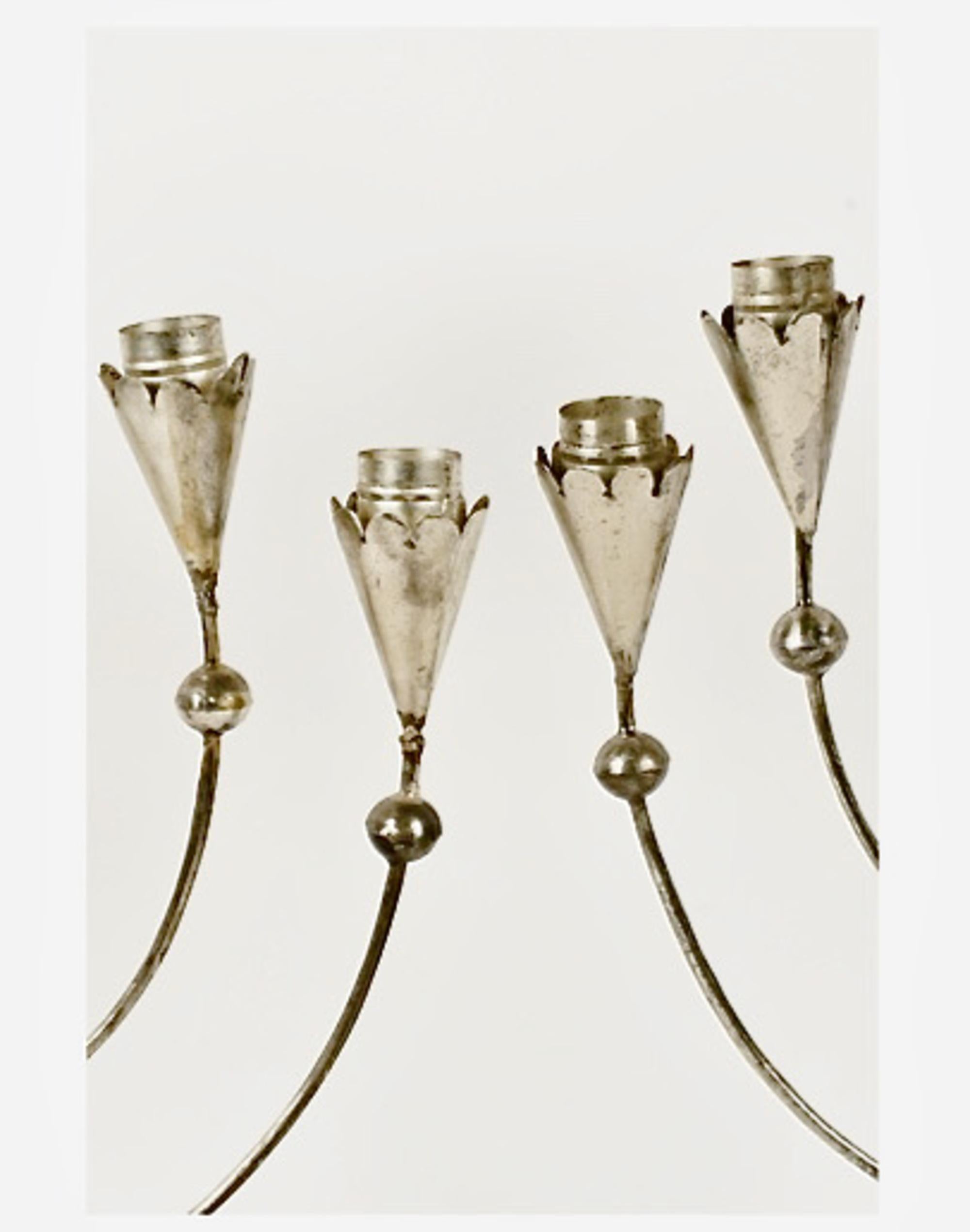 This pair of Spratling Seven-Light Tin Candelabras was created c. 1935 -1945 and is in overall very good condition considering their age and utilitarian purpose and the more fragile nature of the tin with which they are made. Both of the Candelabras