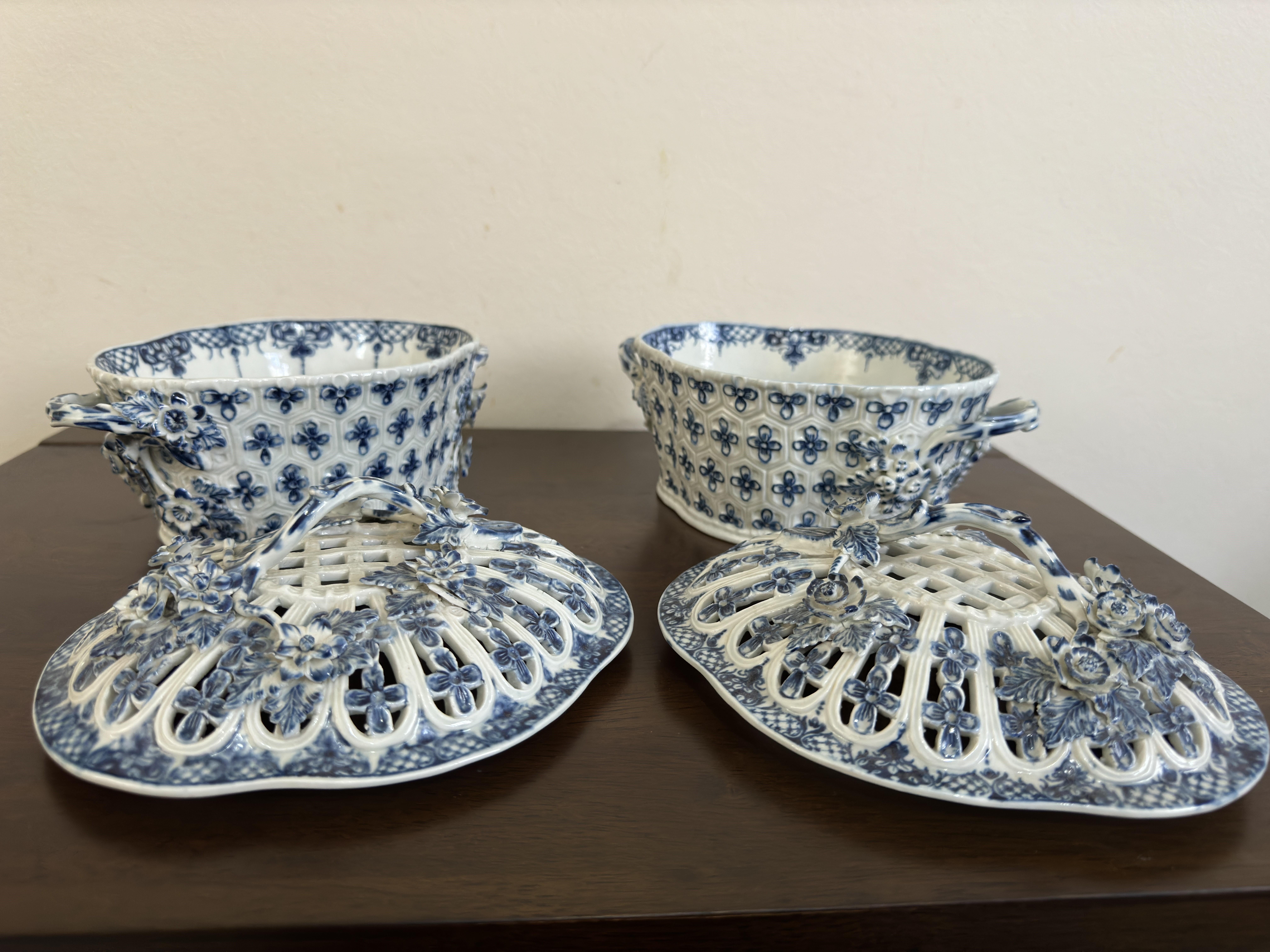 Pair Worcester First Period / Dr Wall chestnut baskets and lids. circa 1780. Blue underglaze porcelain, the body incised with honeycomb pattern and decorated with fleur de lis, loop handles with flowerheads at the terminus, with conforming openwork