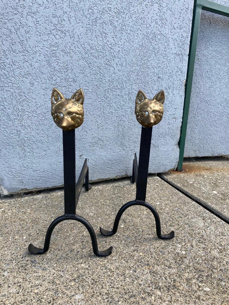 Pair of very foxy andirons. Kidding aside these andirons bring a smile to the face. Amazing how something so simple can have so much personality. Cast bronze fox heads mounted on wrought iron. English 1920's. 
Measures: 19.25 inches high 10 wide