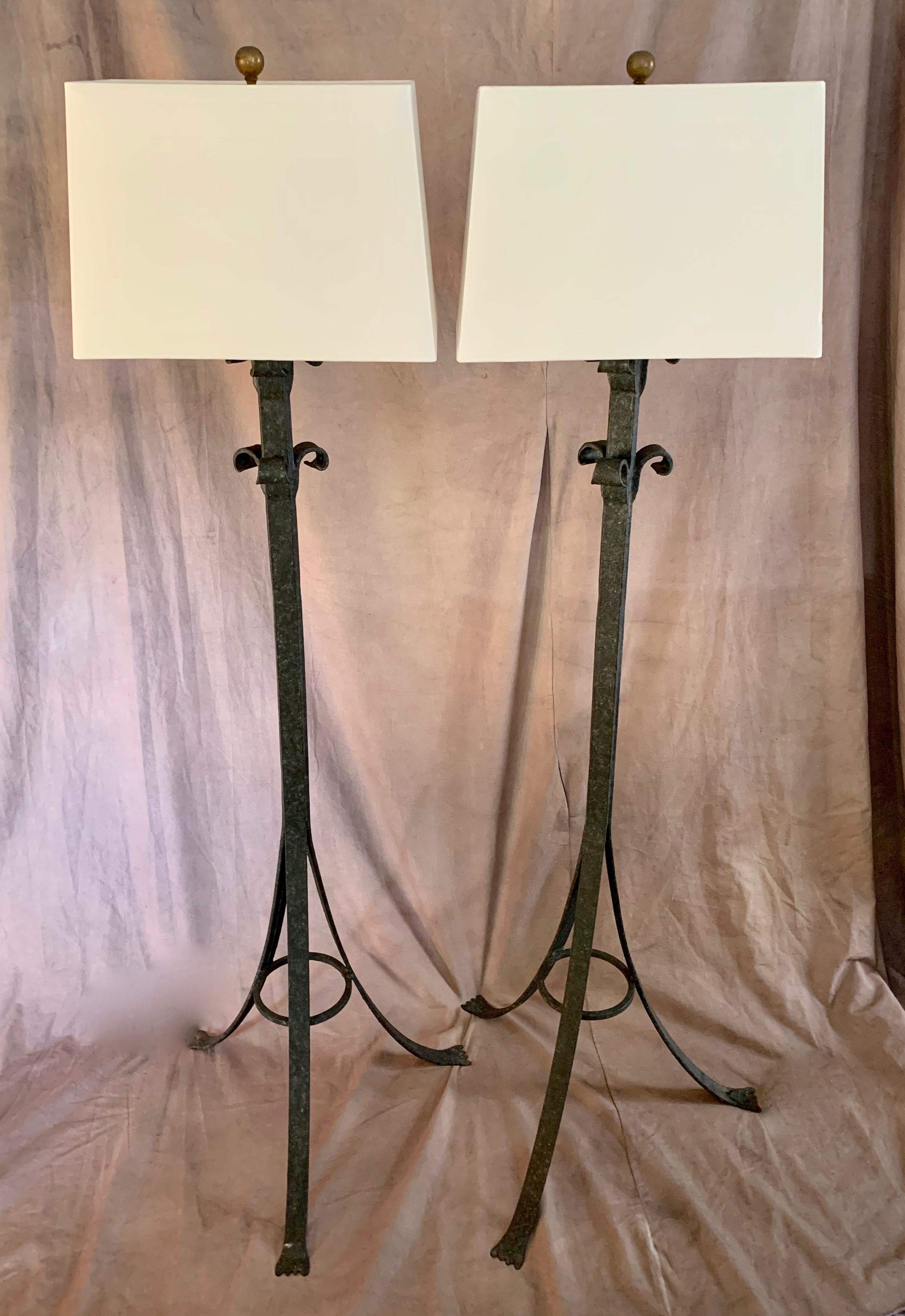 A handsome pair of wrought iron floor lamps - suitable for the living room, den, office or bedroom. A compliment to modern and traditional spaces, especially spaces that lend their tone to Spanish, Moroccan or tribal spaces. Single bulb housing with