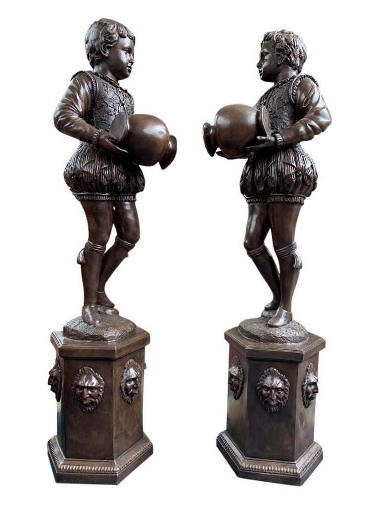 Stunning pair of large bronze statues in the form of a pair of Elizabethan page boys. Each boy holds the urn from where the water would trickle. There is an inlet at the back of the base of the statue for the water. Of course these make great