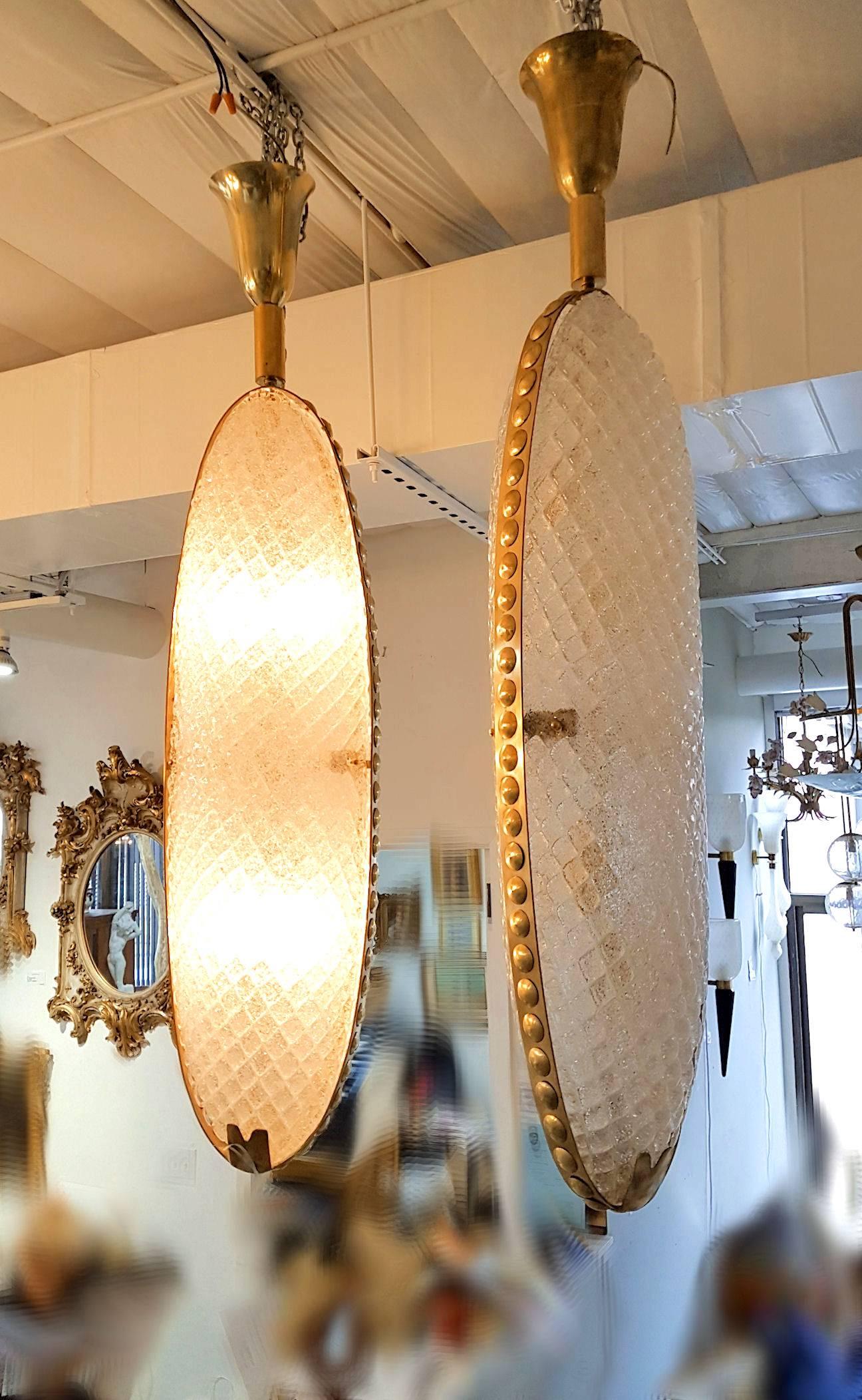 Extra large pair of Mid-Century Modern Murano clear textured translucent Murano glass lanterns or pendants, circled with brass decorative mounts.
Glass is made with Balotton Murano technique, which is a diamond patterned decoration in relief on the