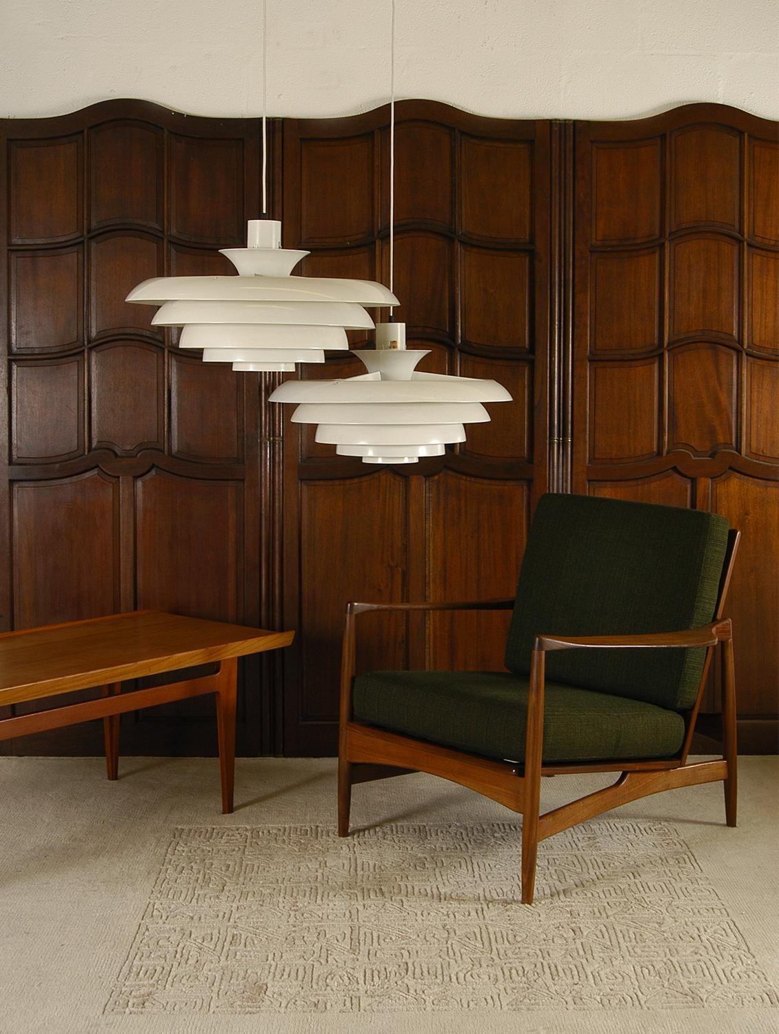 Great pair of substantially sized ceiling lamps by Fagerhults Belysning of Sweden. From a central three-armed steel frame containing the hidden bulb holder, hang four contoured aluminium shade rings each one held to each other by a thin steel wire.