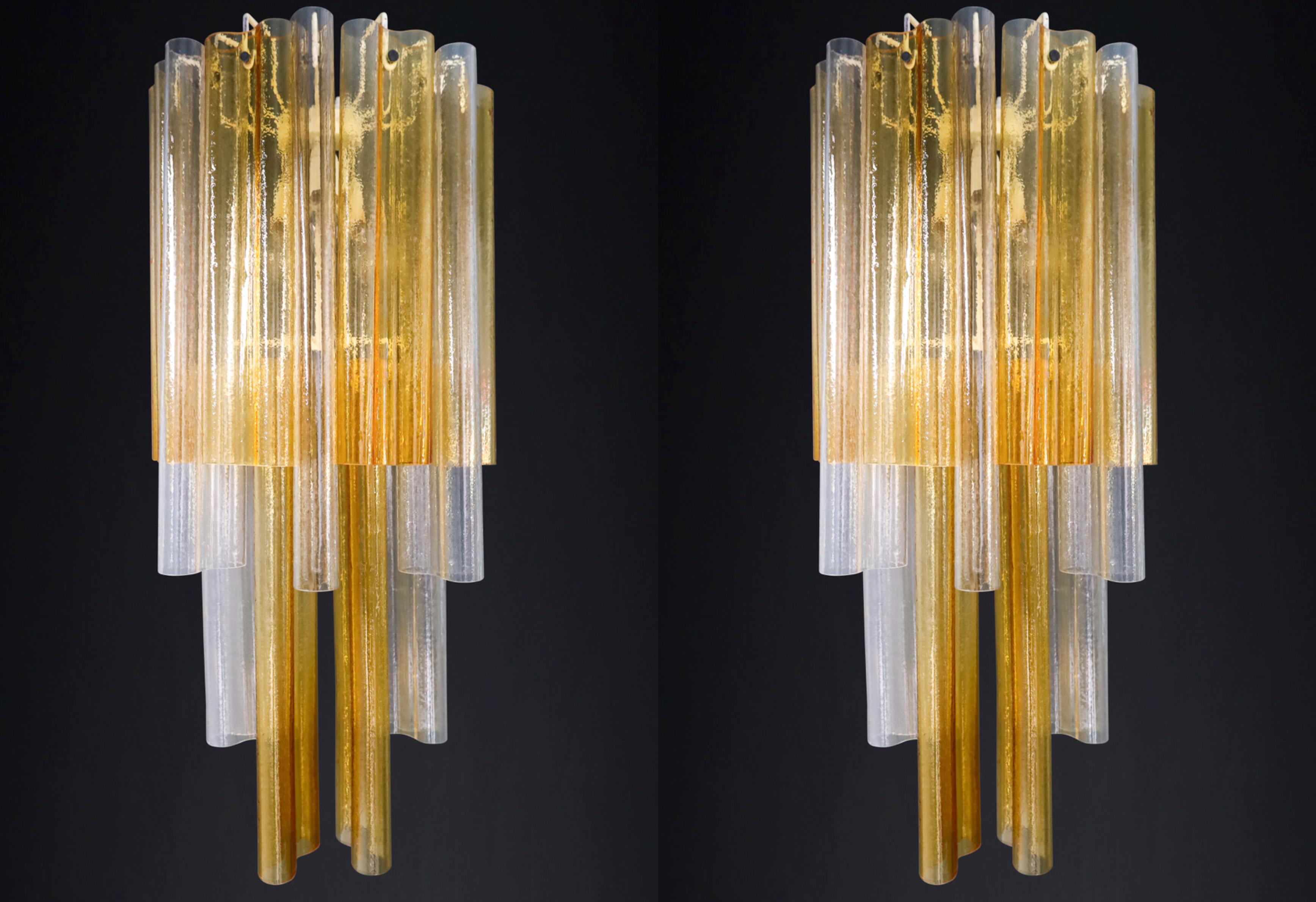 Pair XXL Venini Wall Chandeliers with Murano Amber and Ice Glass, Italy 1960 

We're selling a pair of gorgeous Venini Wall chandeliers from the 1960s, each featuring hand-blown Murano glass in amber and ice tones. These Italian-made lamps are