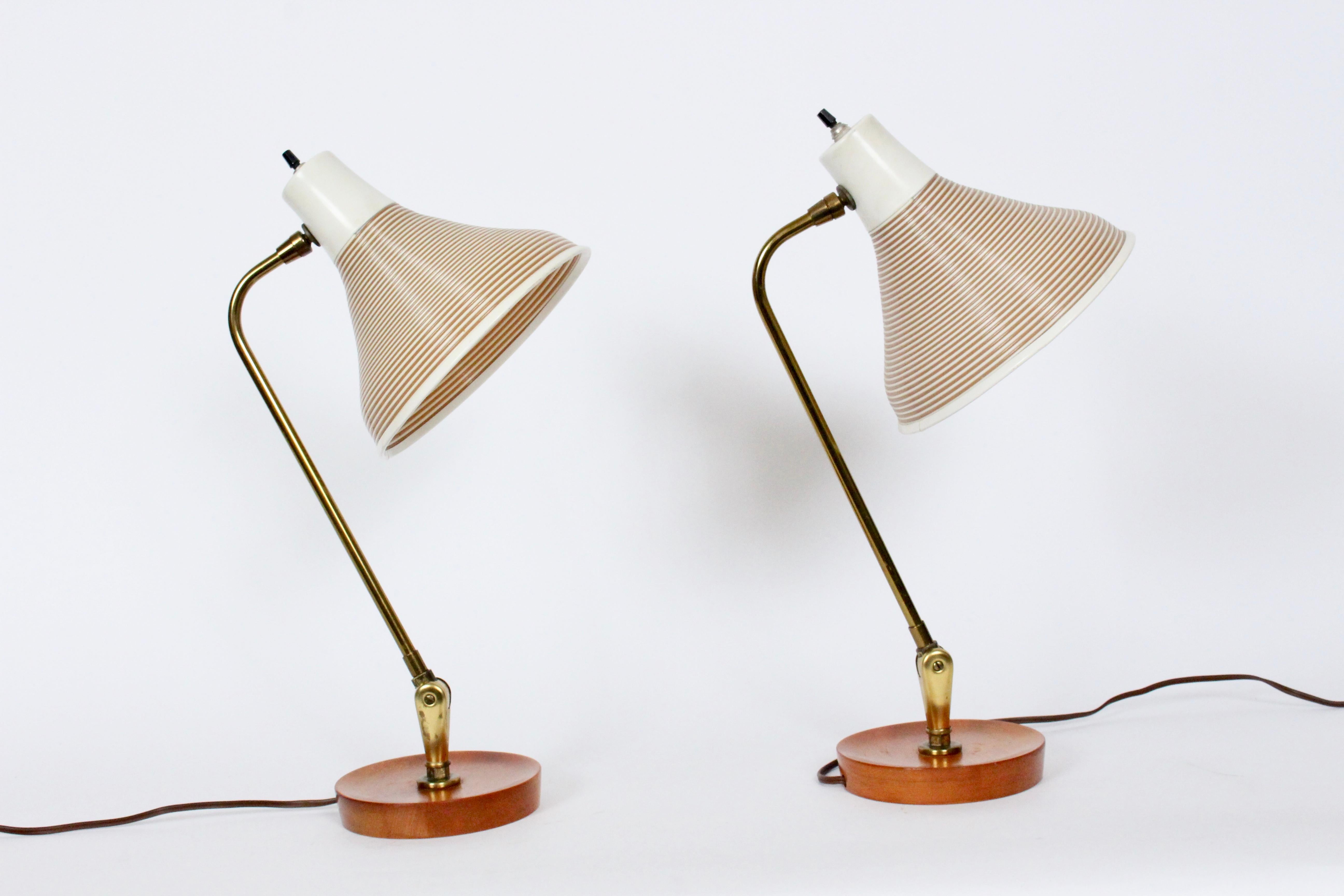 Pair of American Mid-Century Modern adjustable Heifetz Rotaflex Desk Lamps. Featuring original articulating Brass stems, vented Taupe and Off White coiled Rotaflex Bell shades on round, turned Maple, concave candlestick bases and great for holding