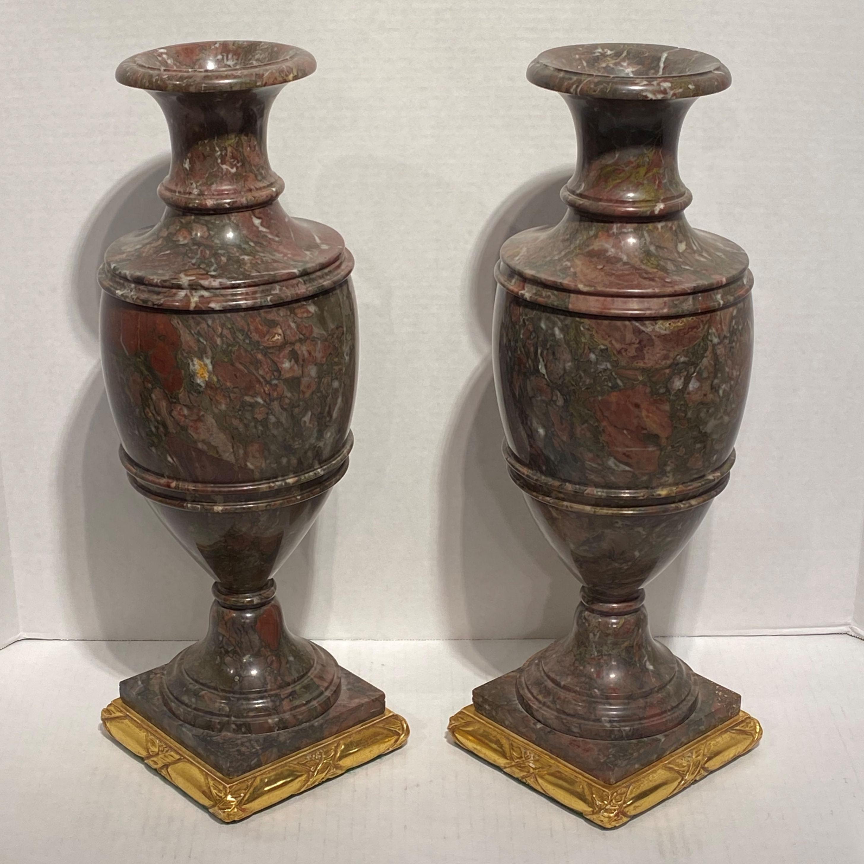 Pair of 19 century Italian neoclassical Rouge marble vases on later giltwood bases.
 