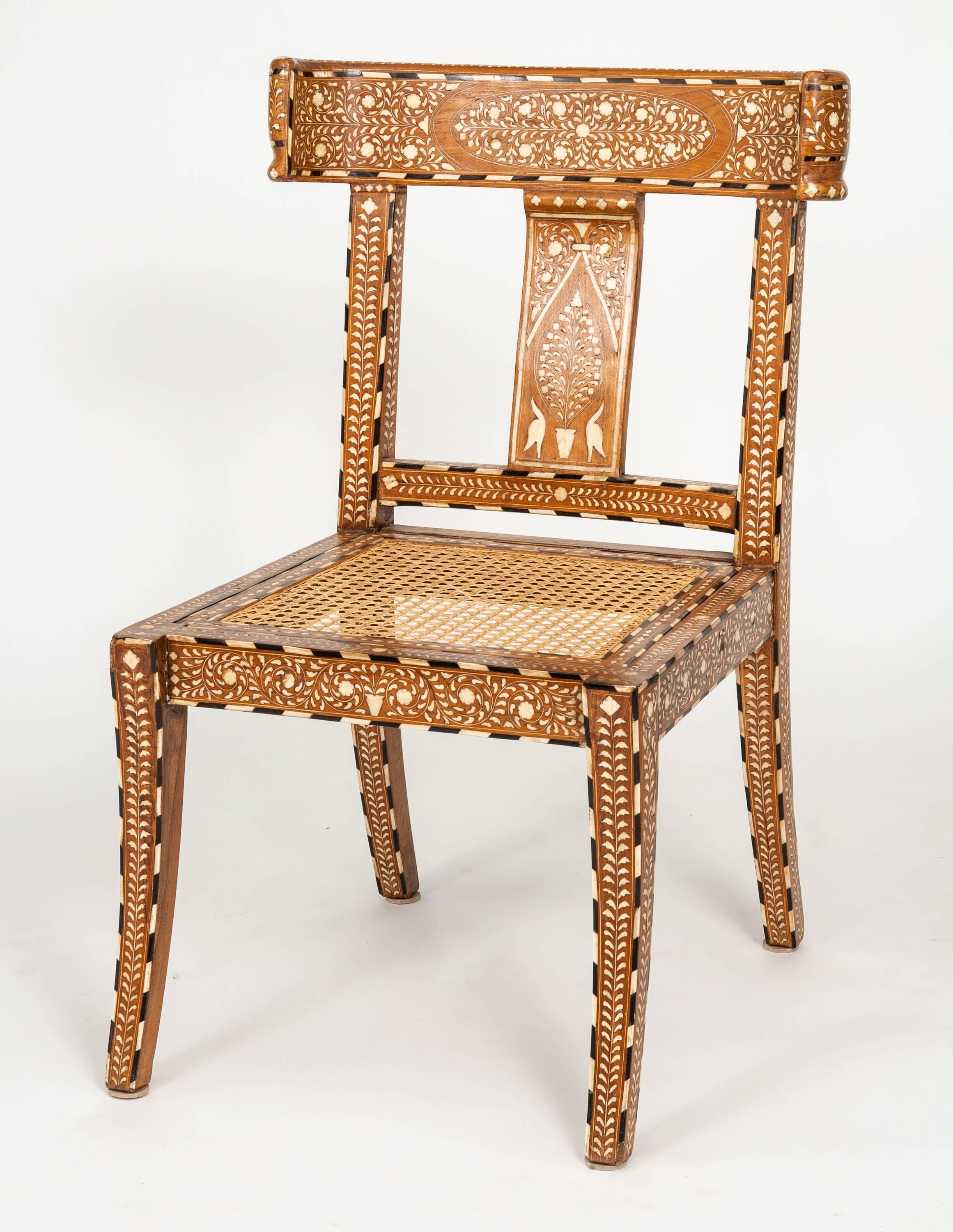 Stylish Klismo style back for comfort, splayed legs and caned seats. Pair of intricately handmade bone inlaid armchairs. Made in India. Beautiful profile, a very comfortable accent chairs.