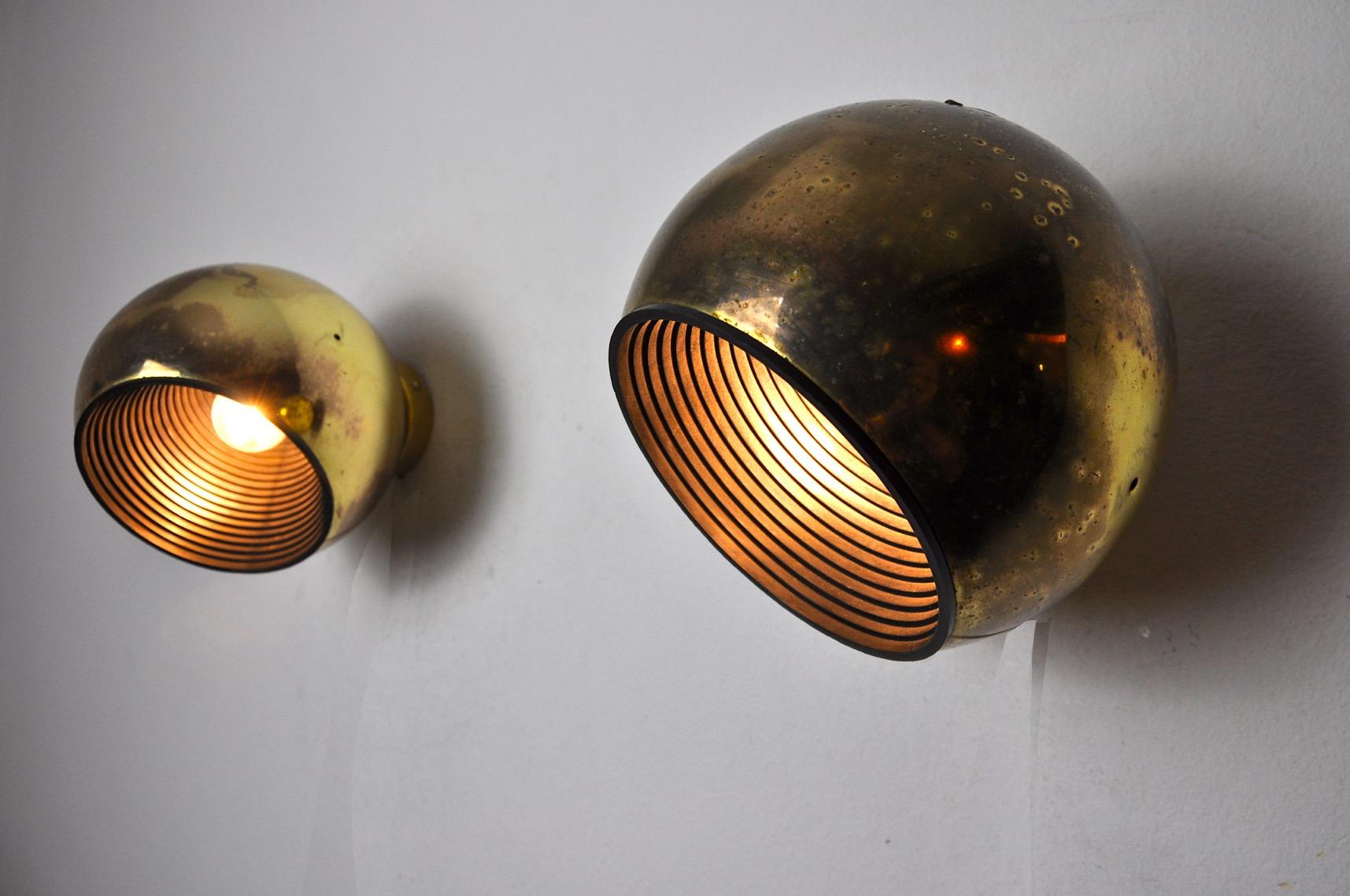 Very nice pair of space-age wall lights designed and produced by the famous fase brand in Spain in the 1970s. Golden metal structure, very beautiful patina, brand label on the back of the wall lights. Unique object that will illuminate wonderfully