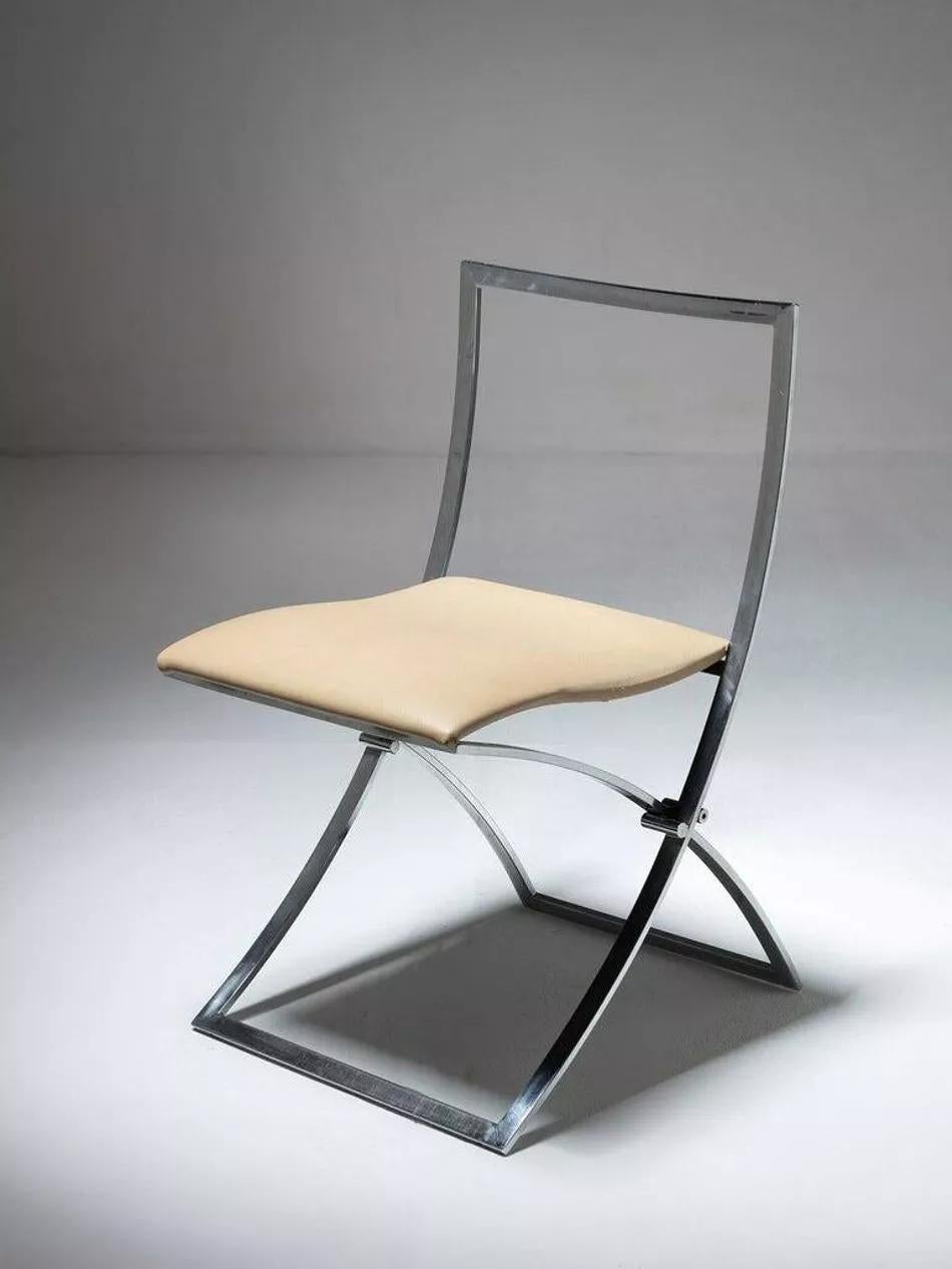 Chaises Luisa. Série de deux chaises pliantes dont l'assise est recouverte de cuir synthétique beige.  Die Luisa, die Anfang der 1970er Jahre von Marcello Cuneo für Mobel entworfen wurde, ist eine verchromte Liege im minimalistischen Design.  Très