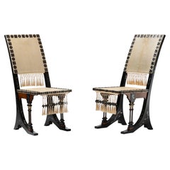 Pair of chairs 1900 by Carlo Bugatti in parchment, blackened wood, and trimmings